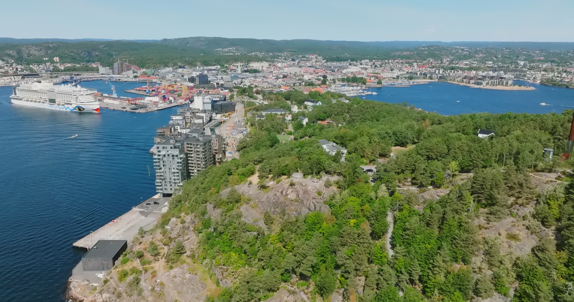 Cliff-edge apartment tower facing the cruise quay, Kristiansand, Norway
