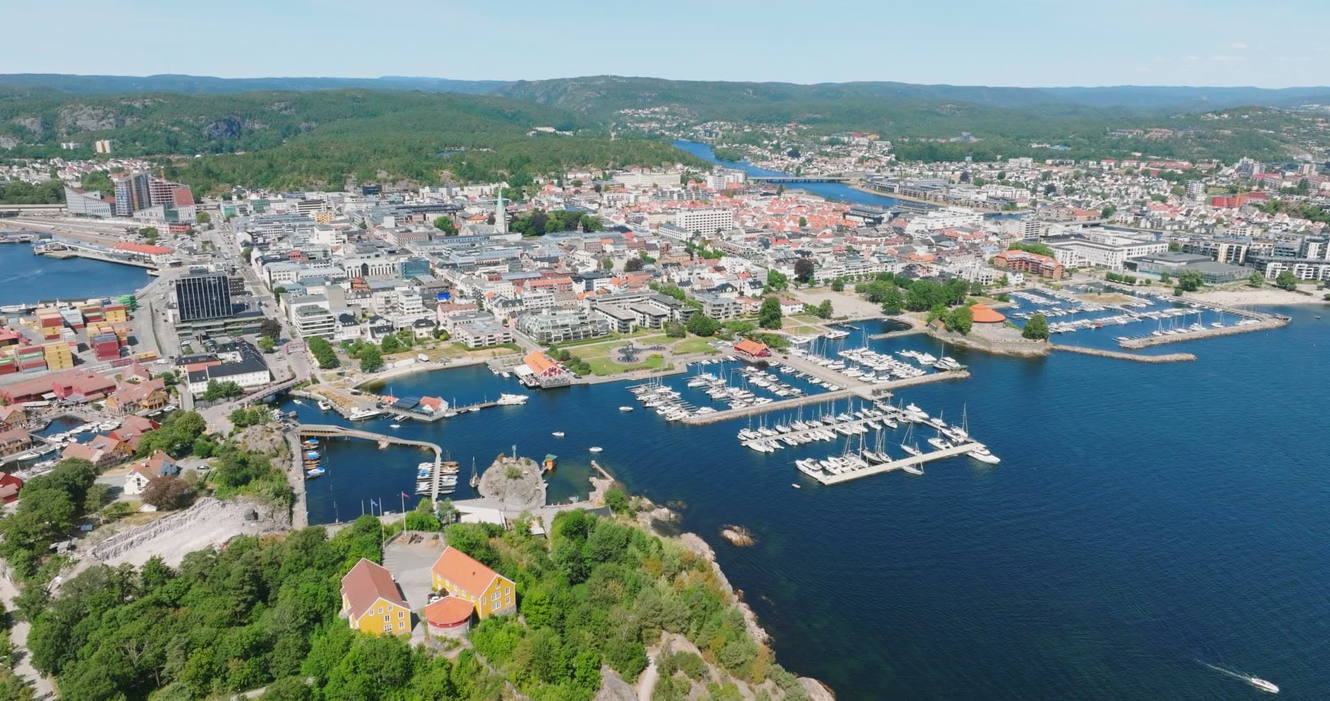 Yellow house on cliff above city marina, Kristiansand, Norway
