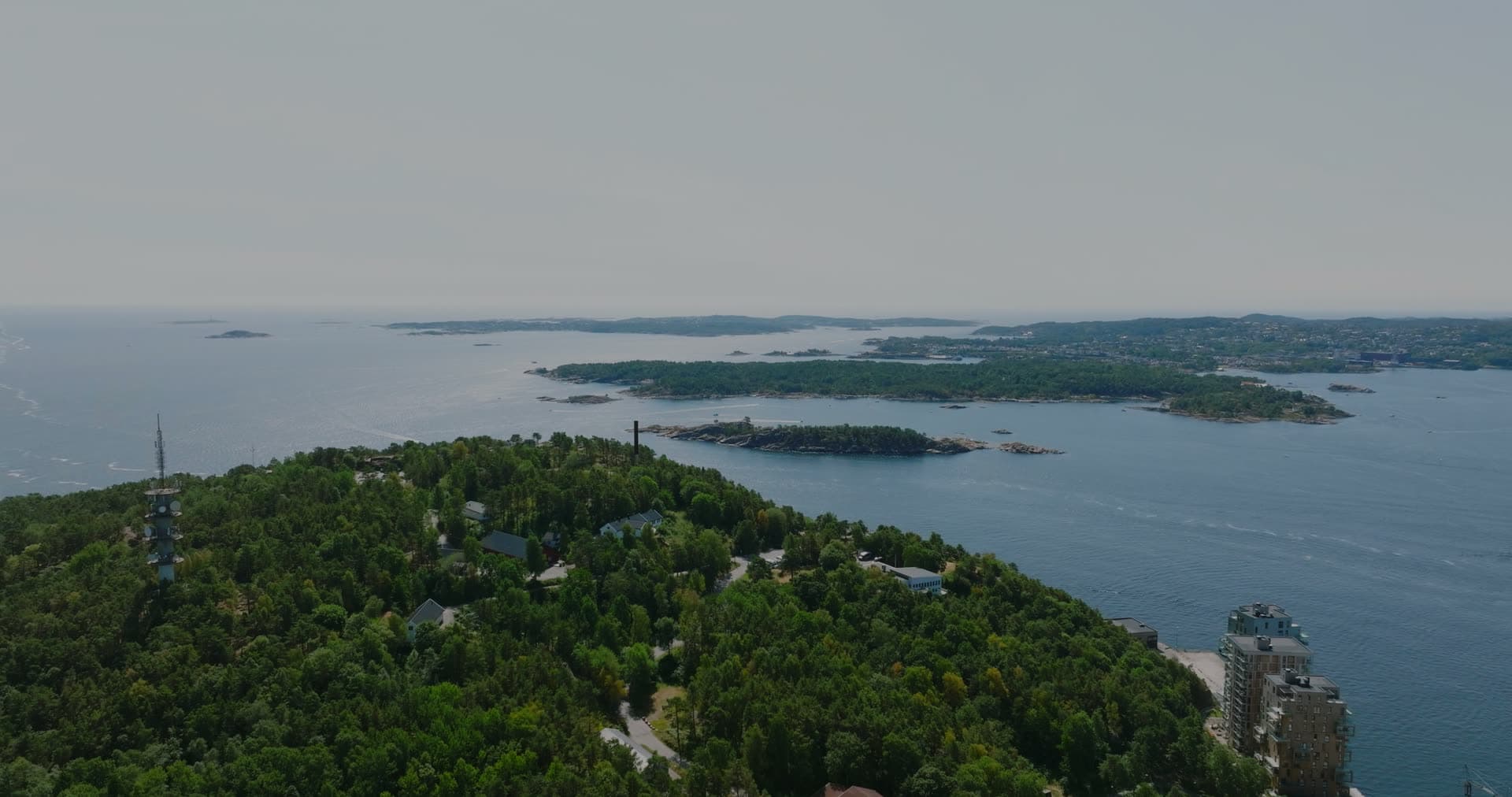 Hazy sea beyond the mast on the headland, Kristiansand, Norway