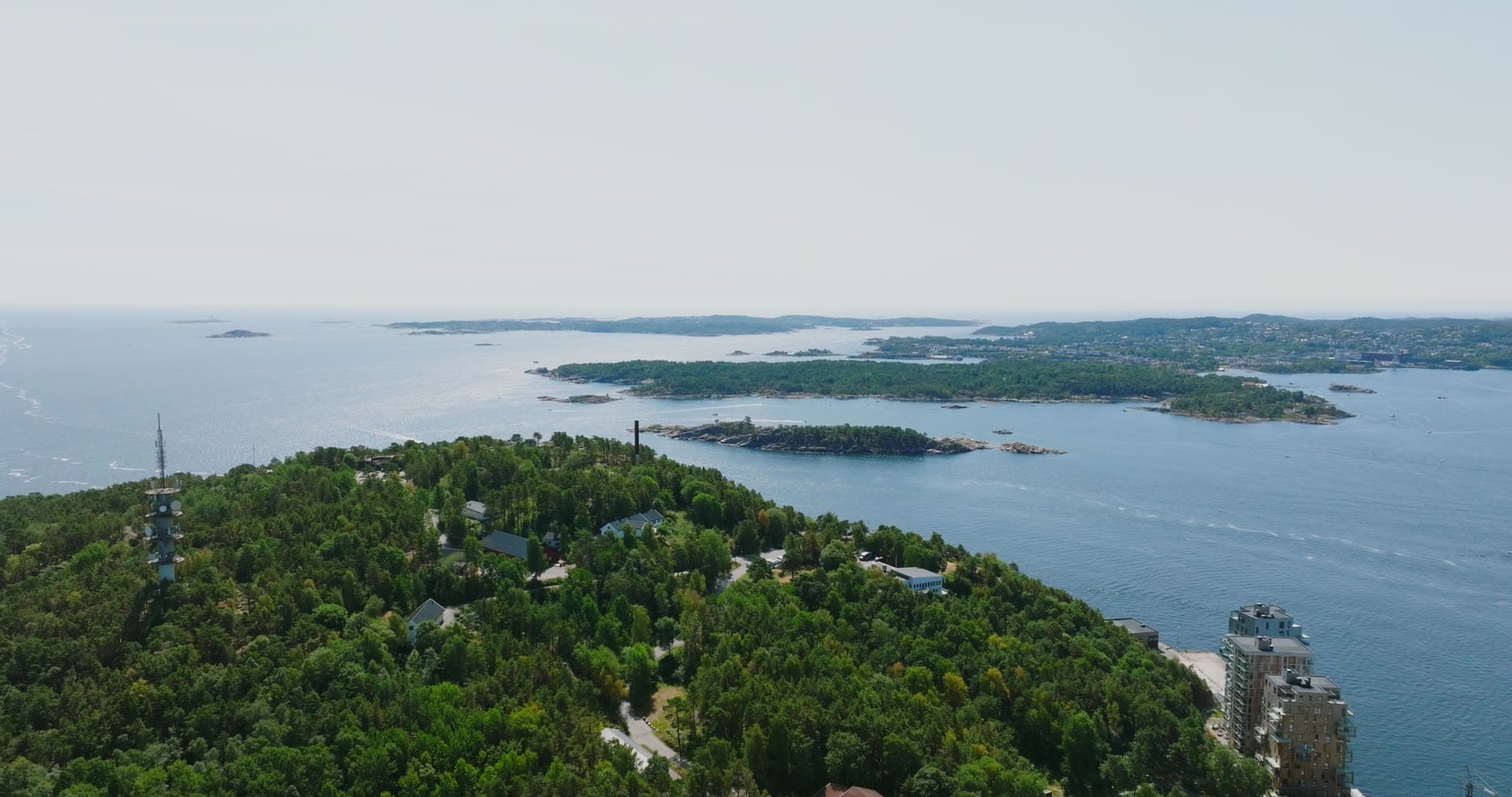Hazy sea beyond the mast on the headland, Kristiansand, Norway