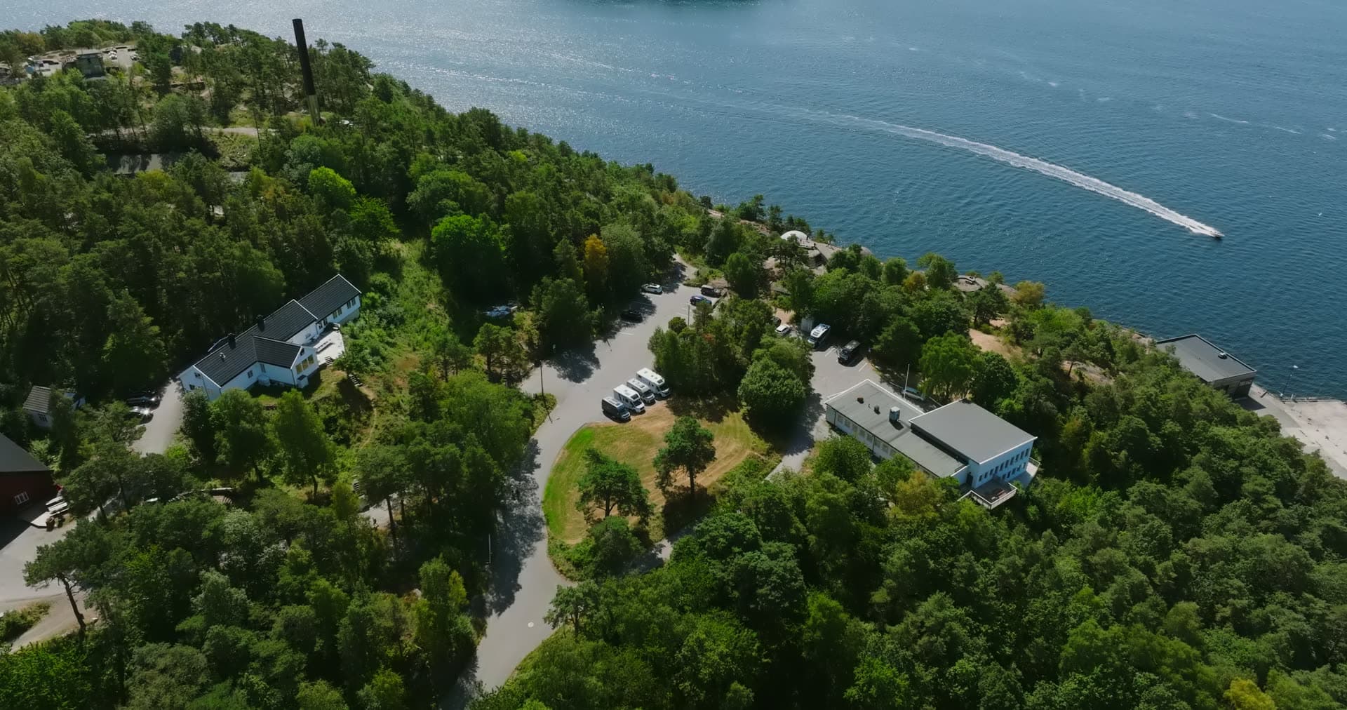 Pine grove buildings and car park by the shore, Kristiansand, Norway