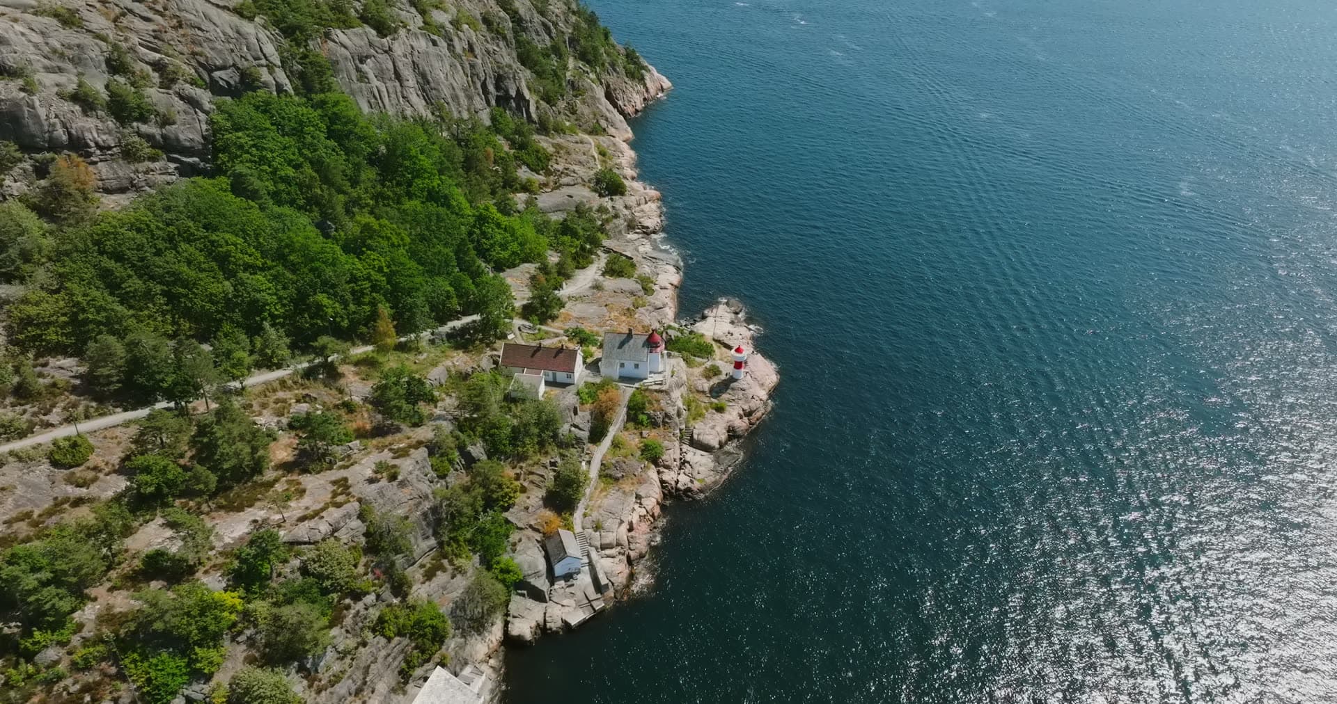Lighthouse and keeper's house on the rocky point, Kristiansand, Norway