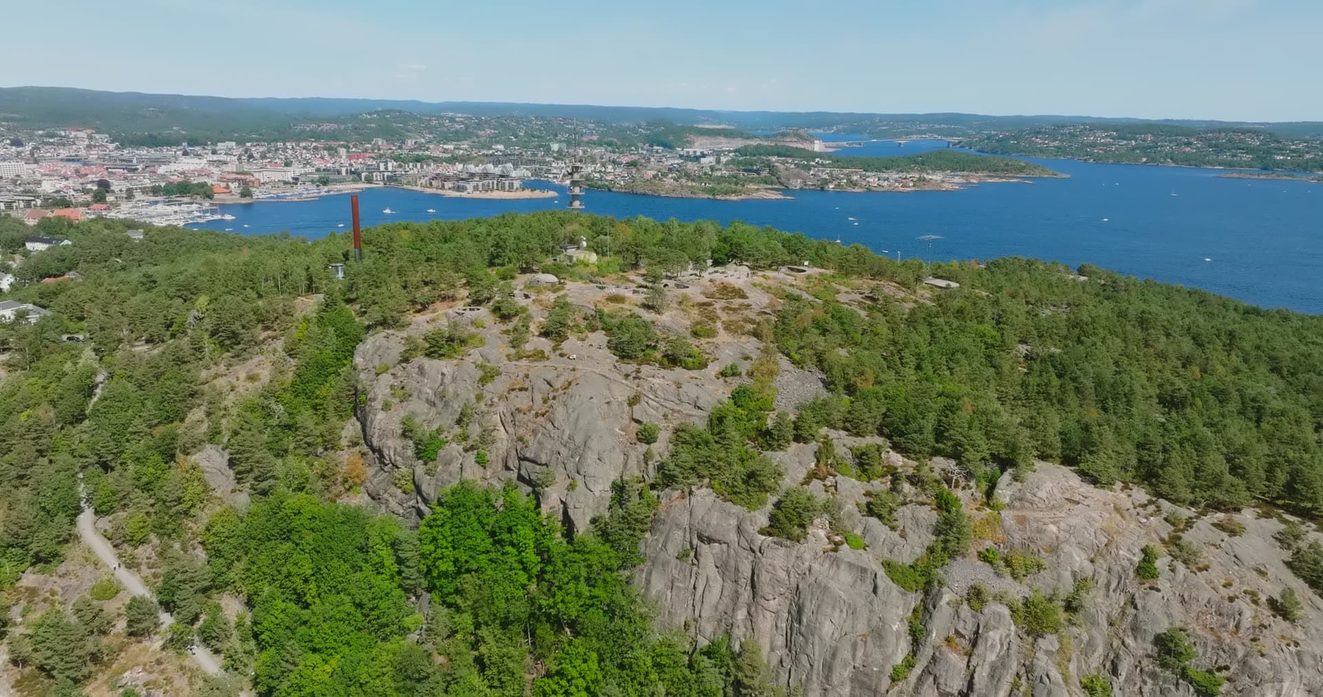 Granite cliff and red mast above the city, Kristiansand, Norway