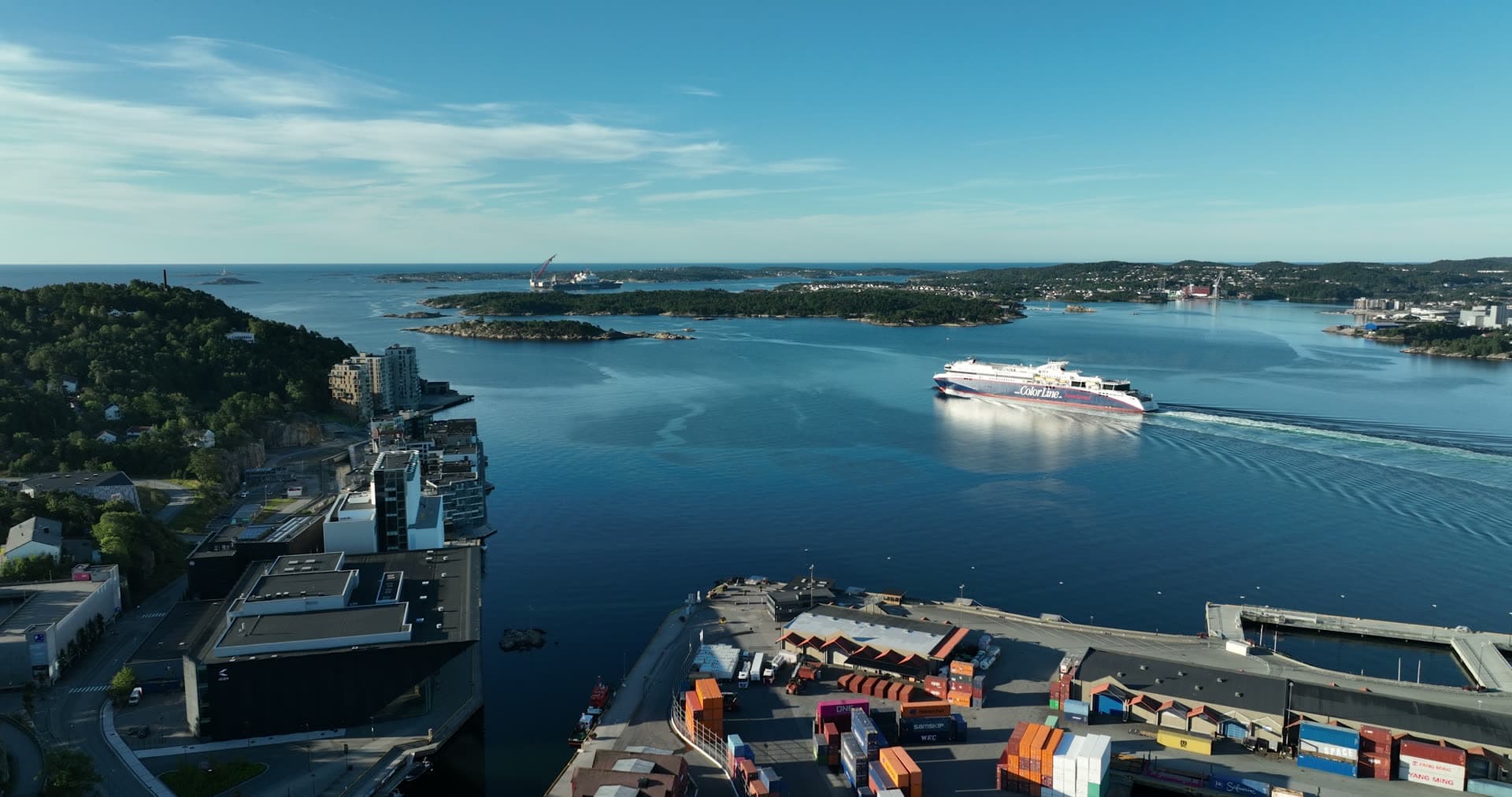 Ferry departing past container terminal, Kristiansand, Norway