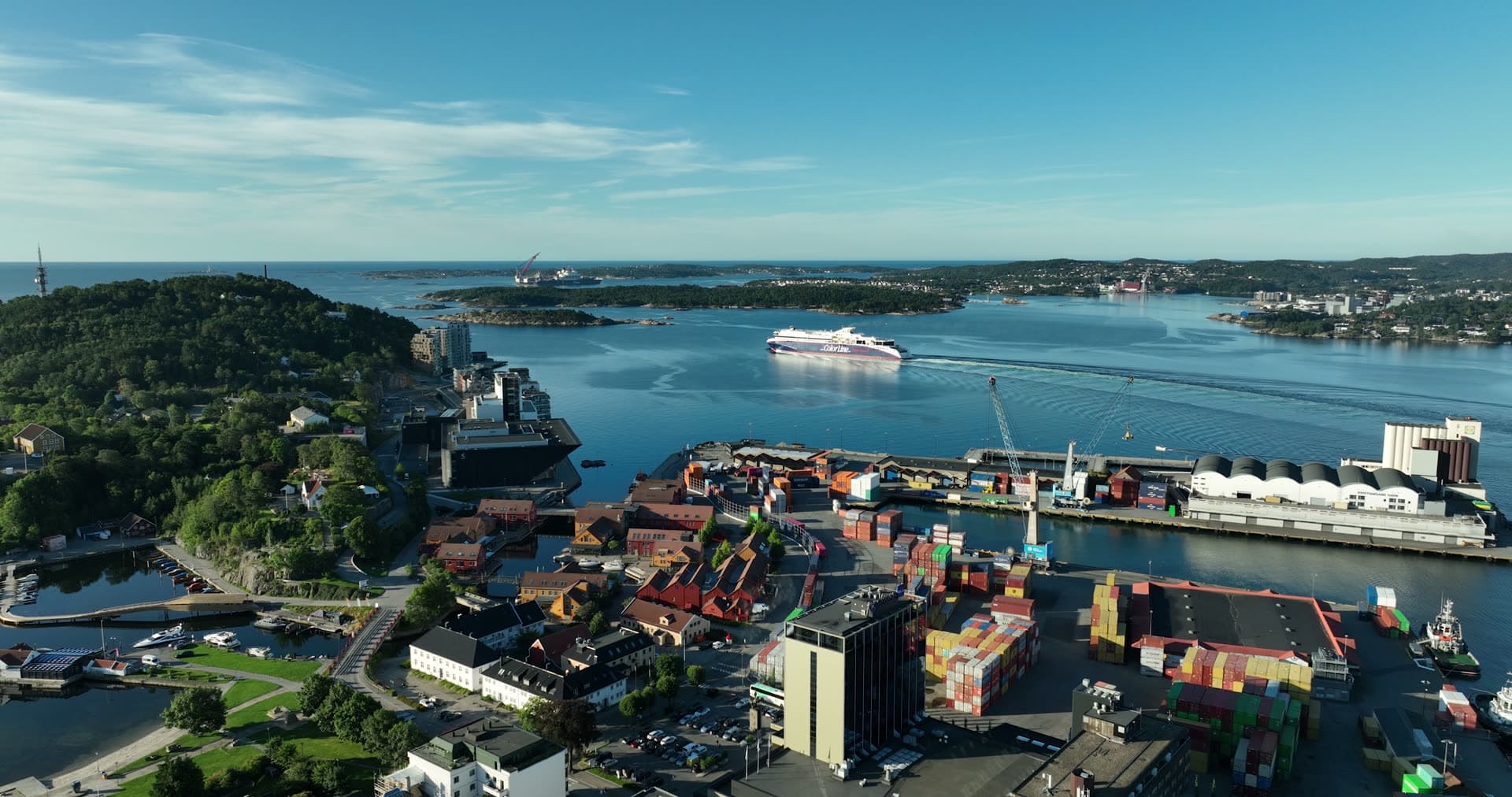 Ferry departing past container port, Kristiansand, Norway