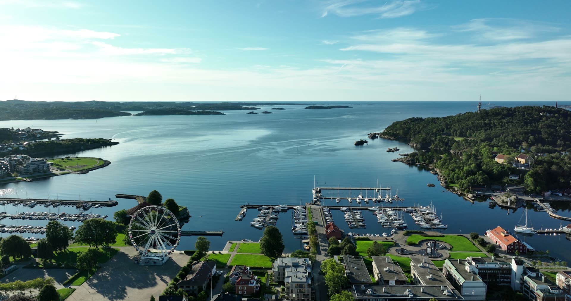 Ferris wheel by marina docks and islets, Kristiansand, Norway