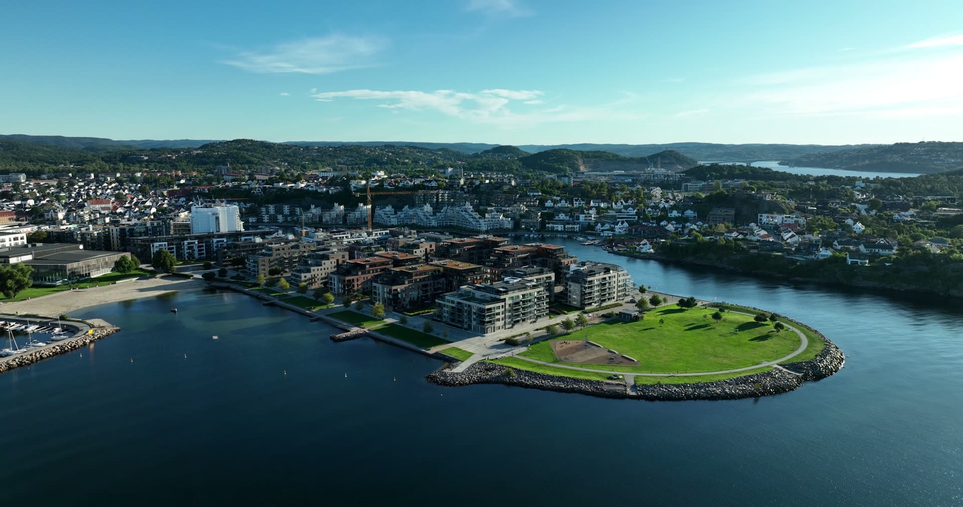 Grass headland with rock rim by flats, Kristiansand, Norway