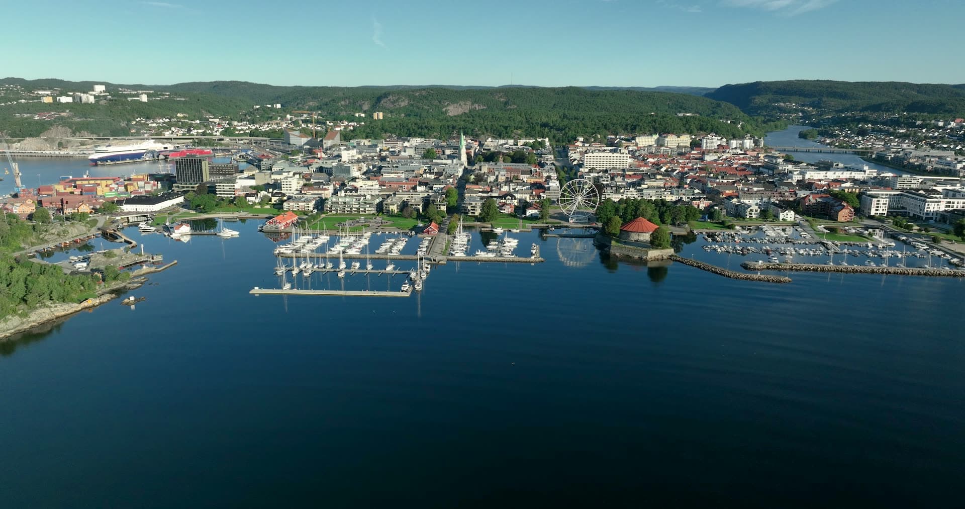 Ferris wheel and marina along town waterfront, Kristiansand, Norway