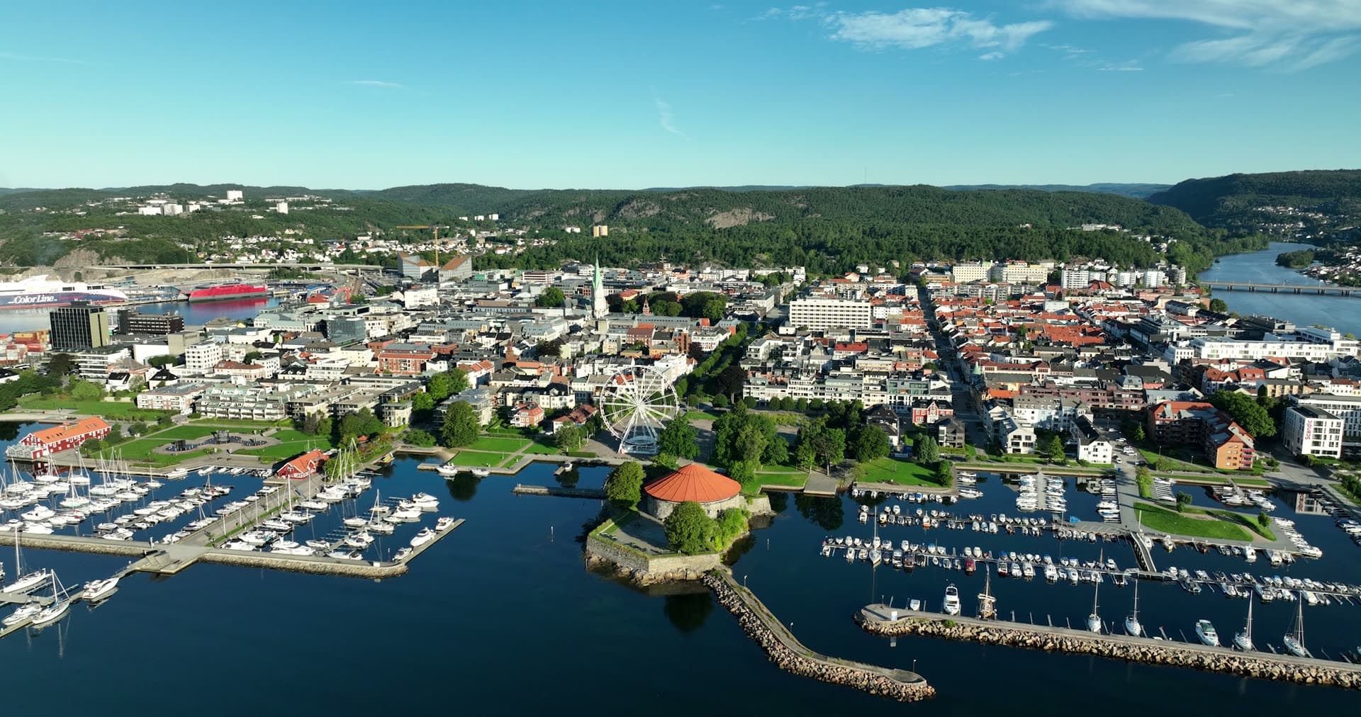 Round fortress and ferris wheel by marinas, Kristiansand, Norway