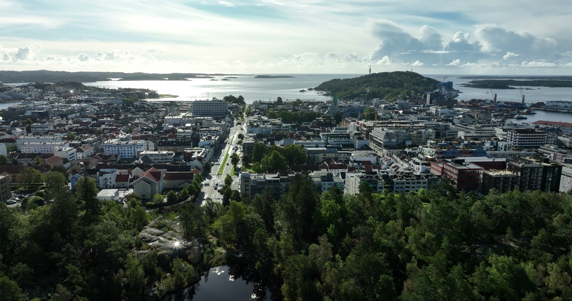 Wooded pond above city avenue to the sea, Kristiansand, Norway