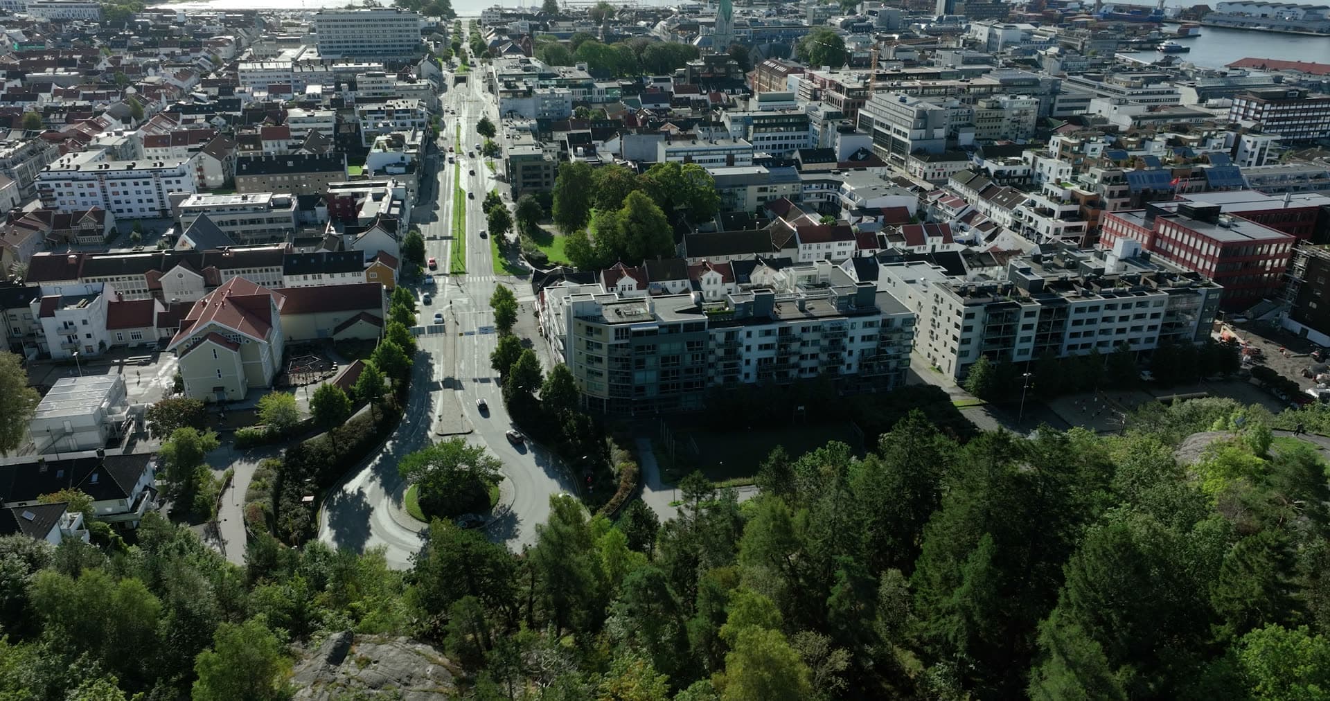 Rising over wooded ridge to city avenue, Kristiansand, Norway