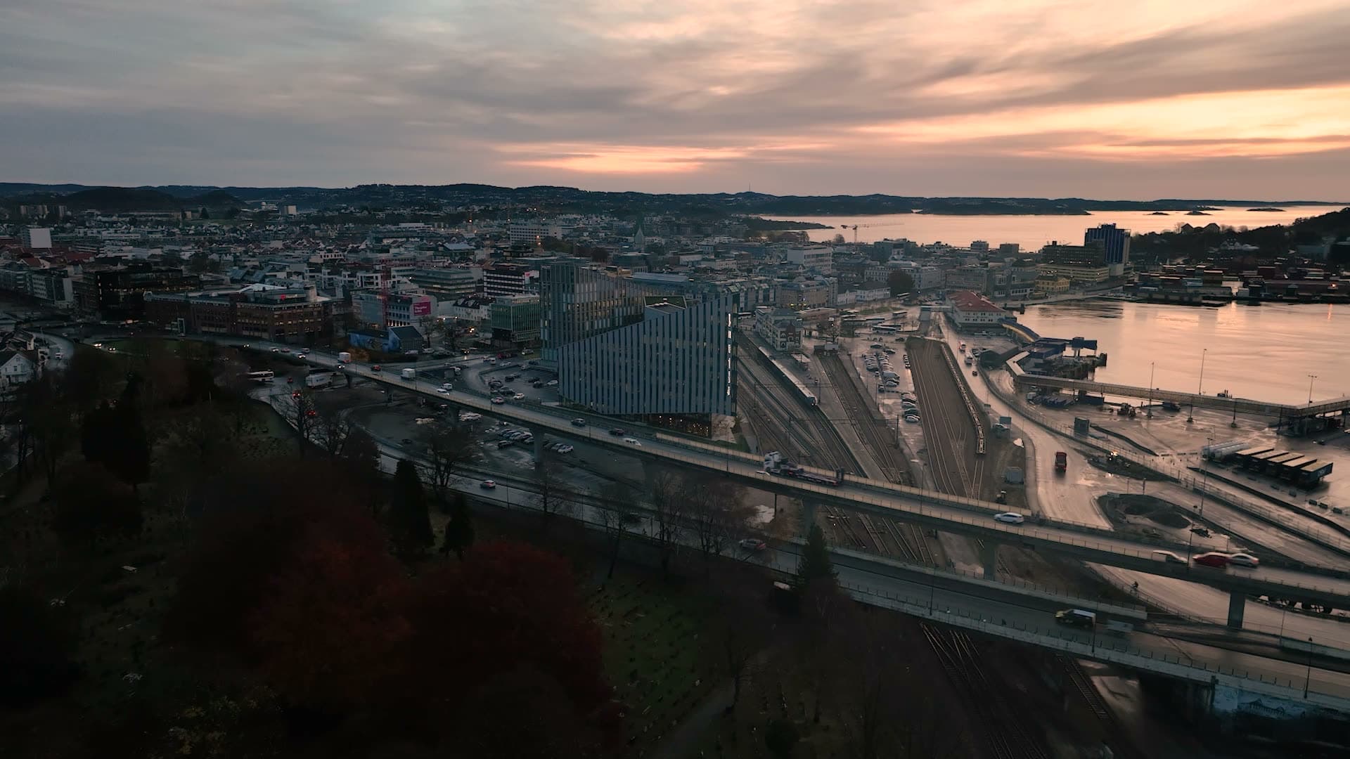 Highway and rail yard by harbor at dusk, Kristiansand, Norway