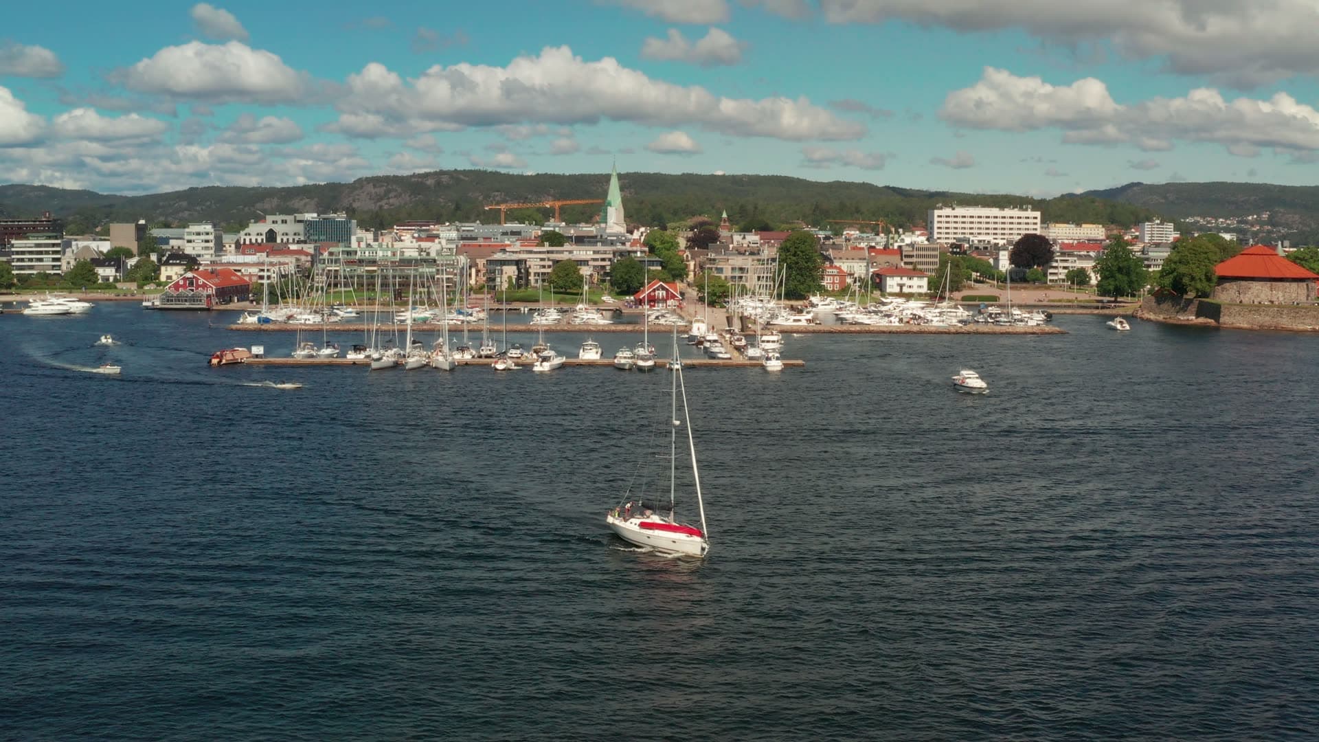 Sailboat under motor off marina piers, Kristiansand, Norway
