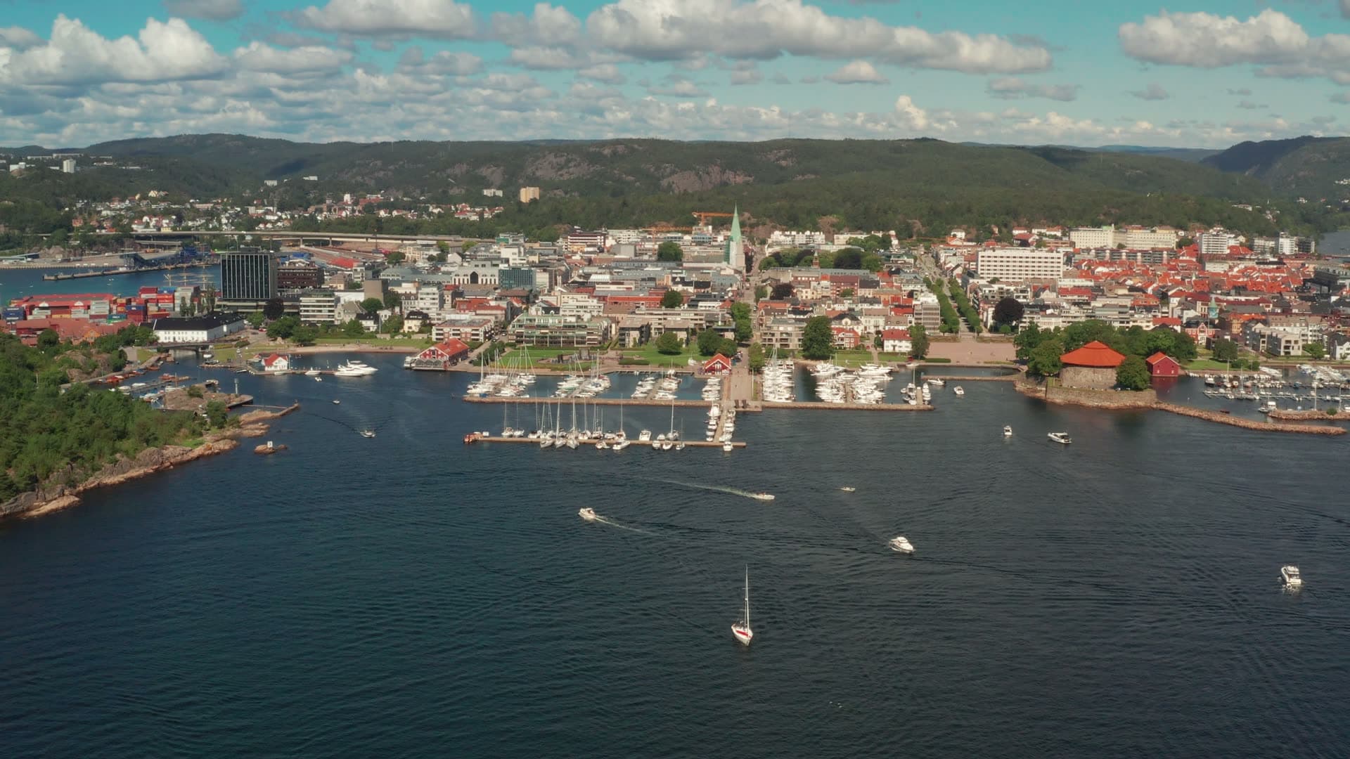 Boats crossing bay toward town marina, Kristiansand, Norway