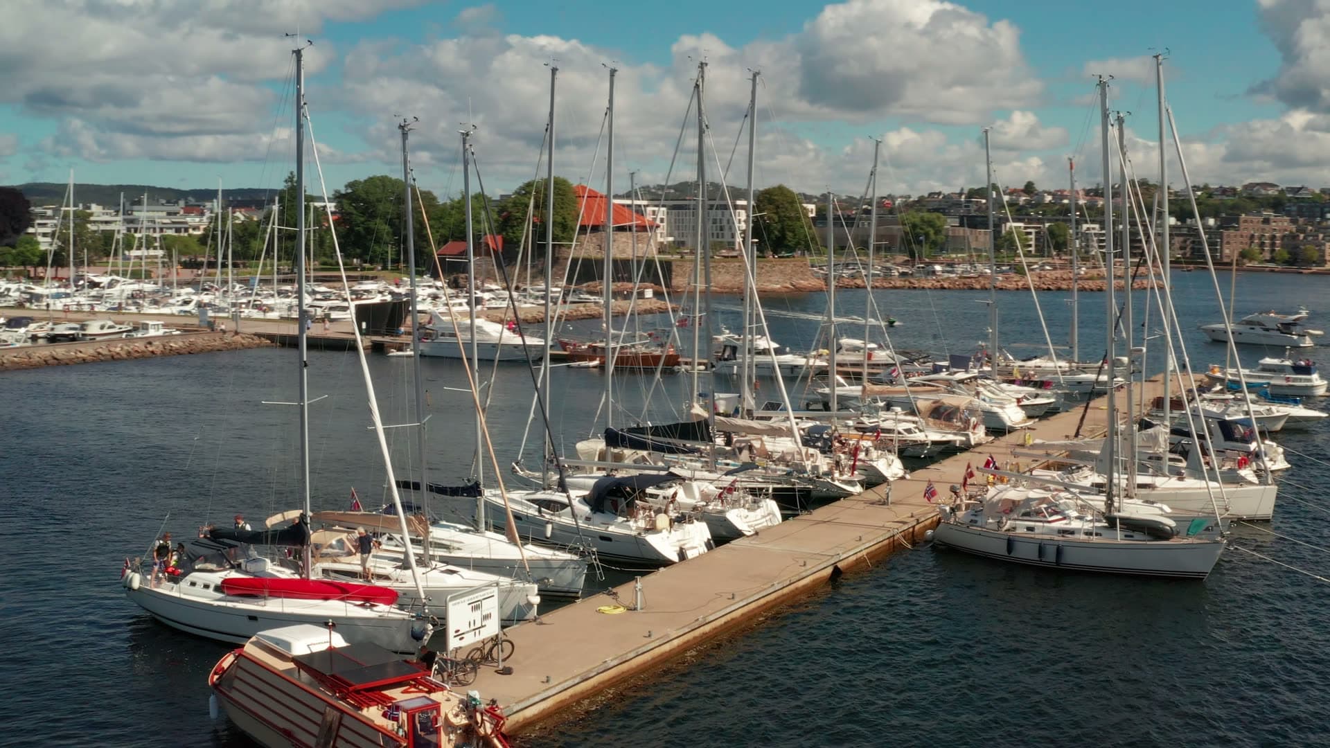 Sailboats moored along marina guest pier, Kristiansand, Norway
