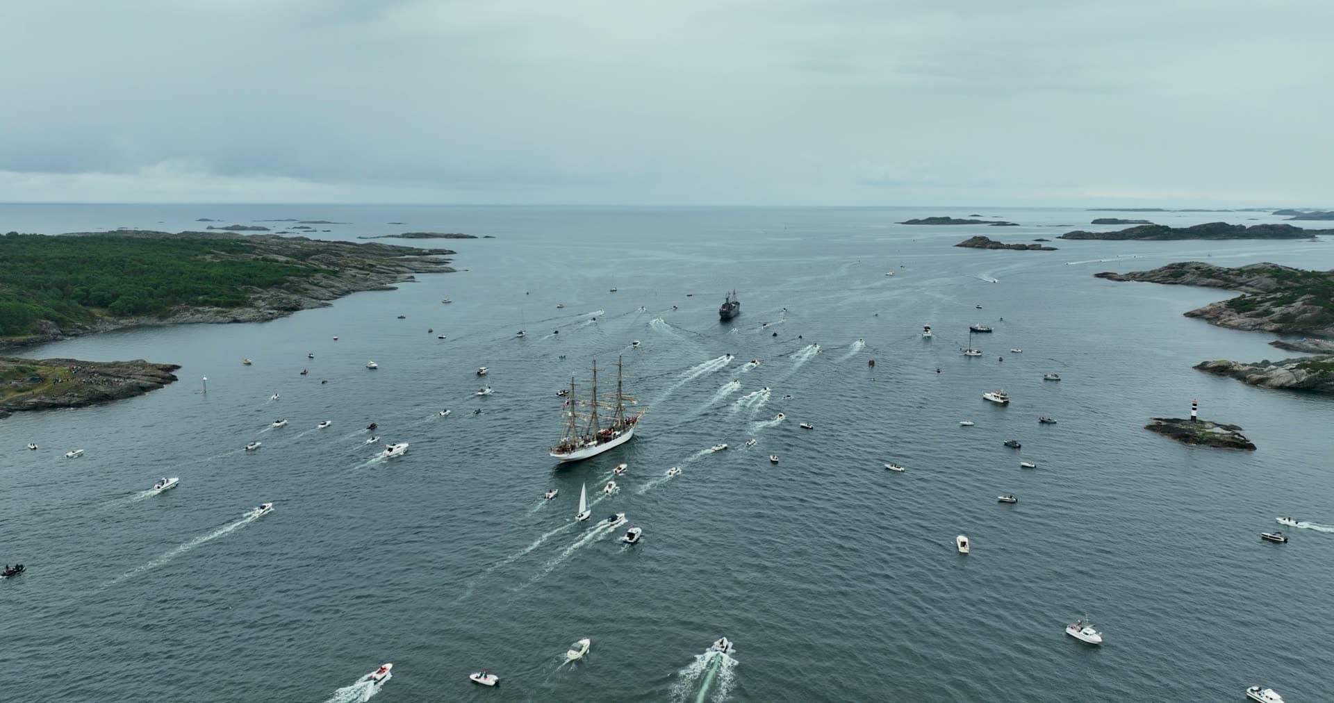 Tall ship escorted by boat flotilla, Kristiansand, Norway