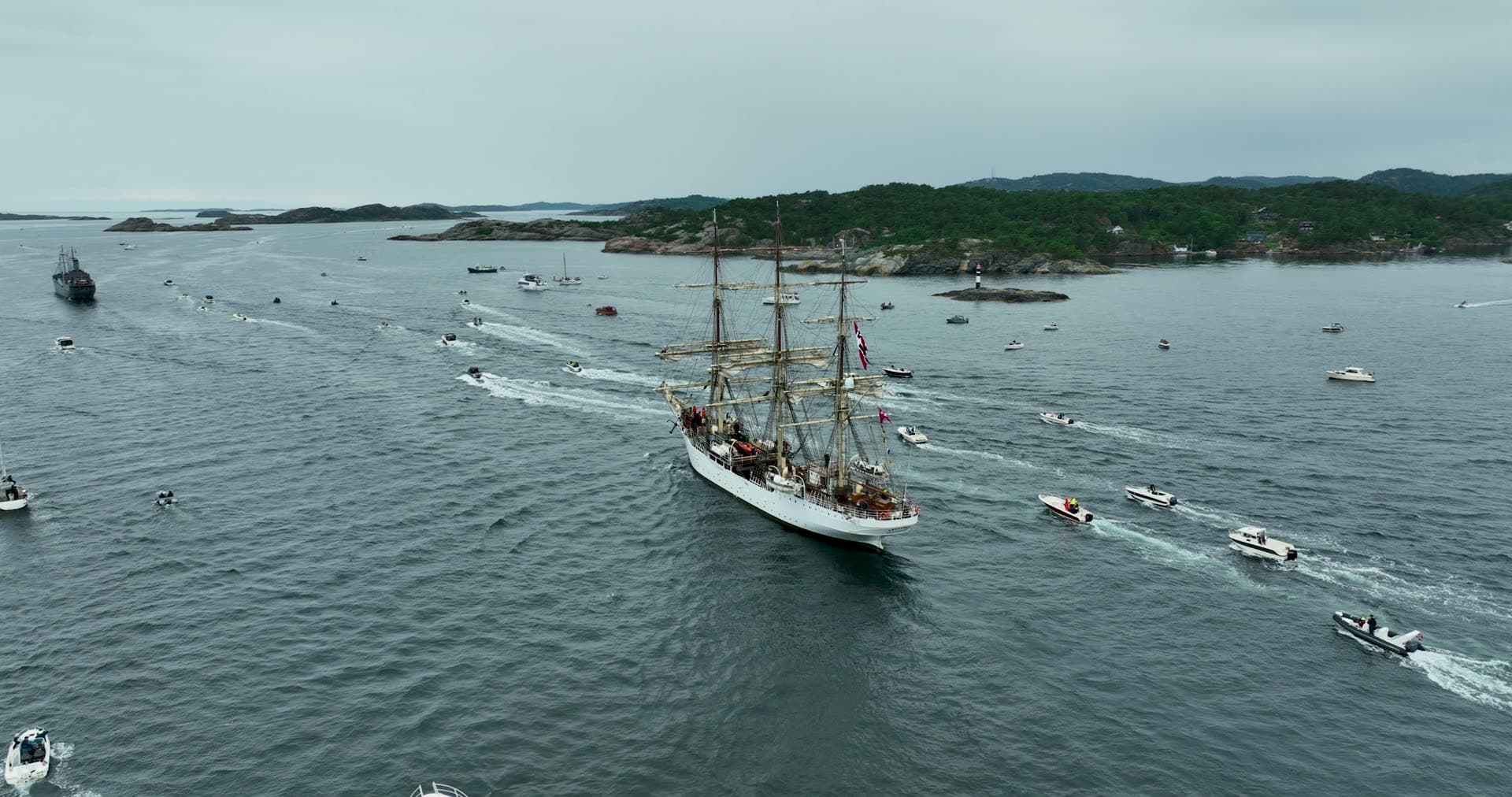 Tall ship escorted by boat flotilla, Kristiansand, Norway