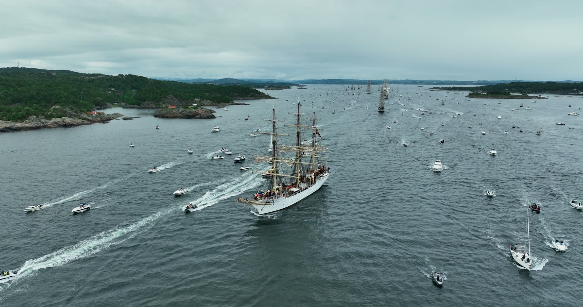 Tall ship parade escorted by small boats, Kristiansand, Norway