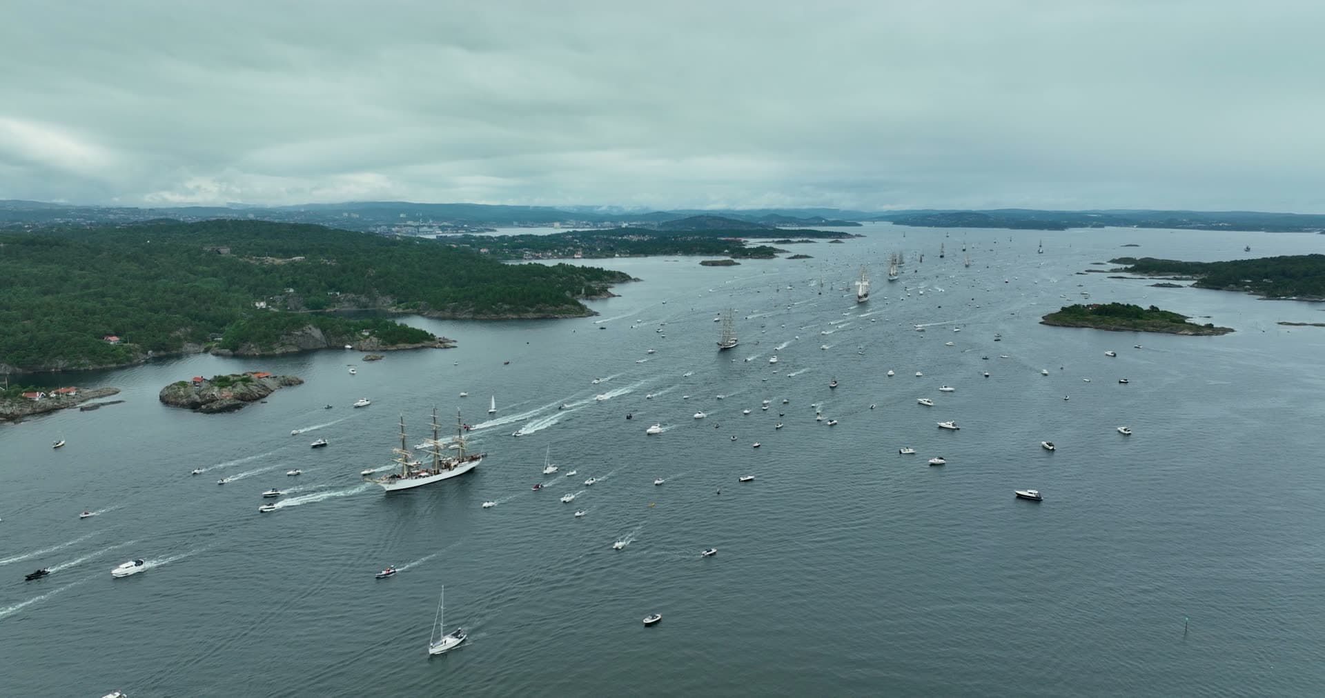 Tall ships parade trailed by boat fleet, Kristiansand, Norway