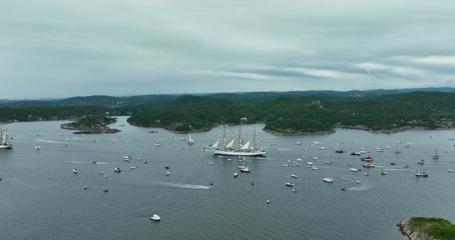 Tall ship parade among crowd of small boats, Kristiansand, Norway