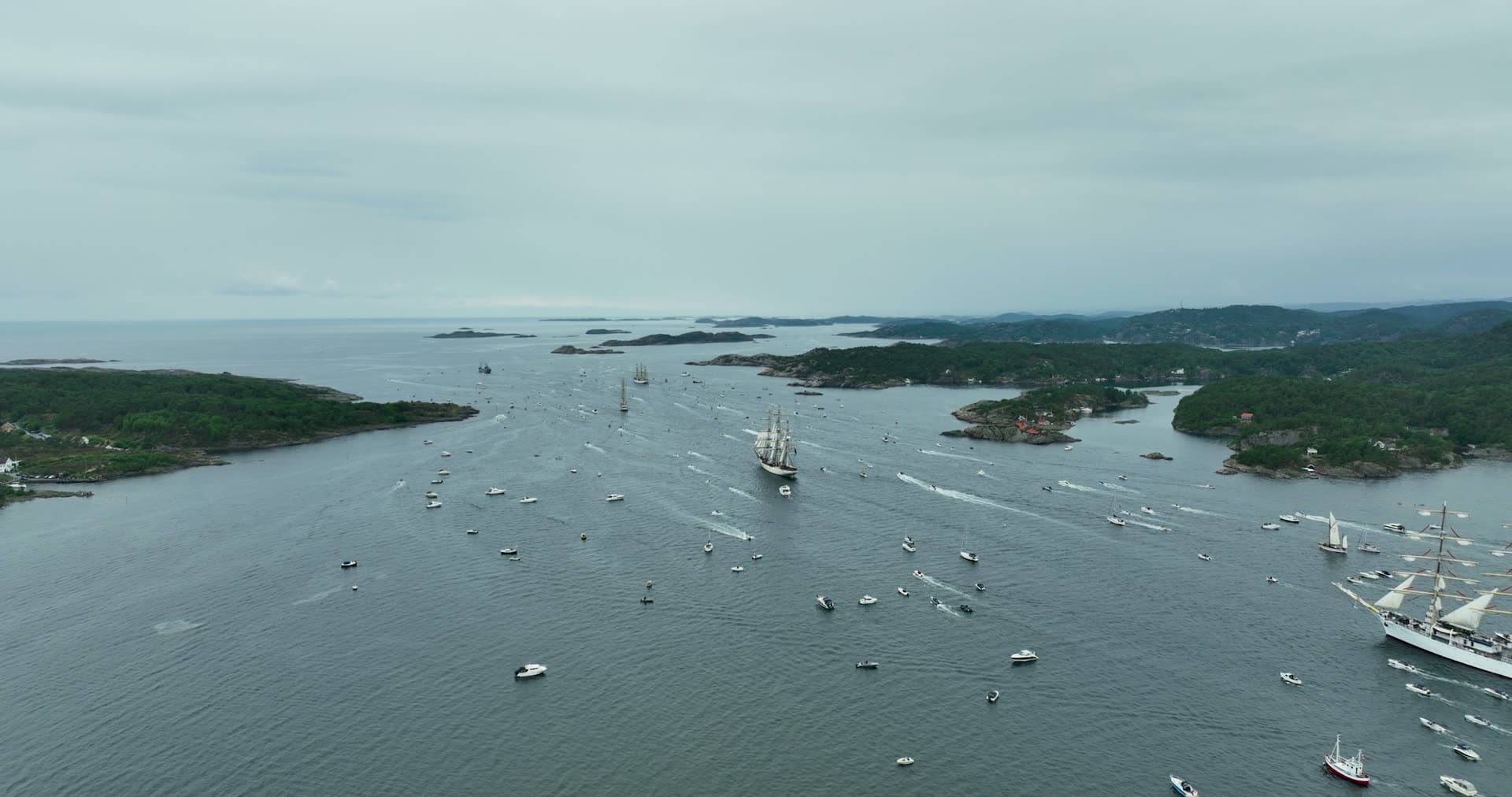 Tall ships parade trailed by small boats, Kristiansand, Norway