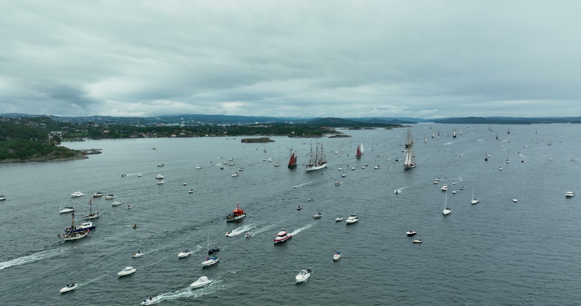 Tall ship parade escorted by motorboats, Kristiansand, Norway