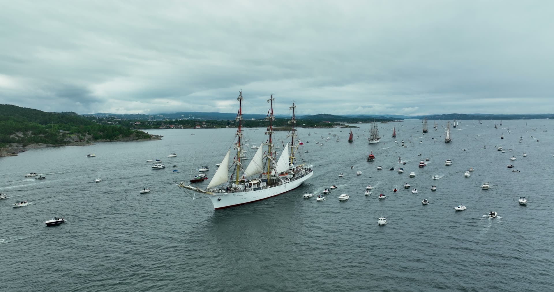 Tall ship parade escorted by small boats, Kristiansand, Norway