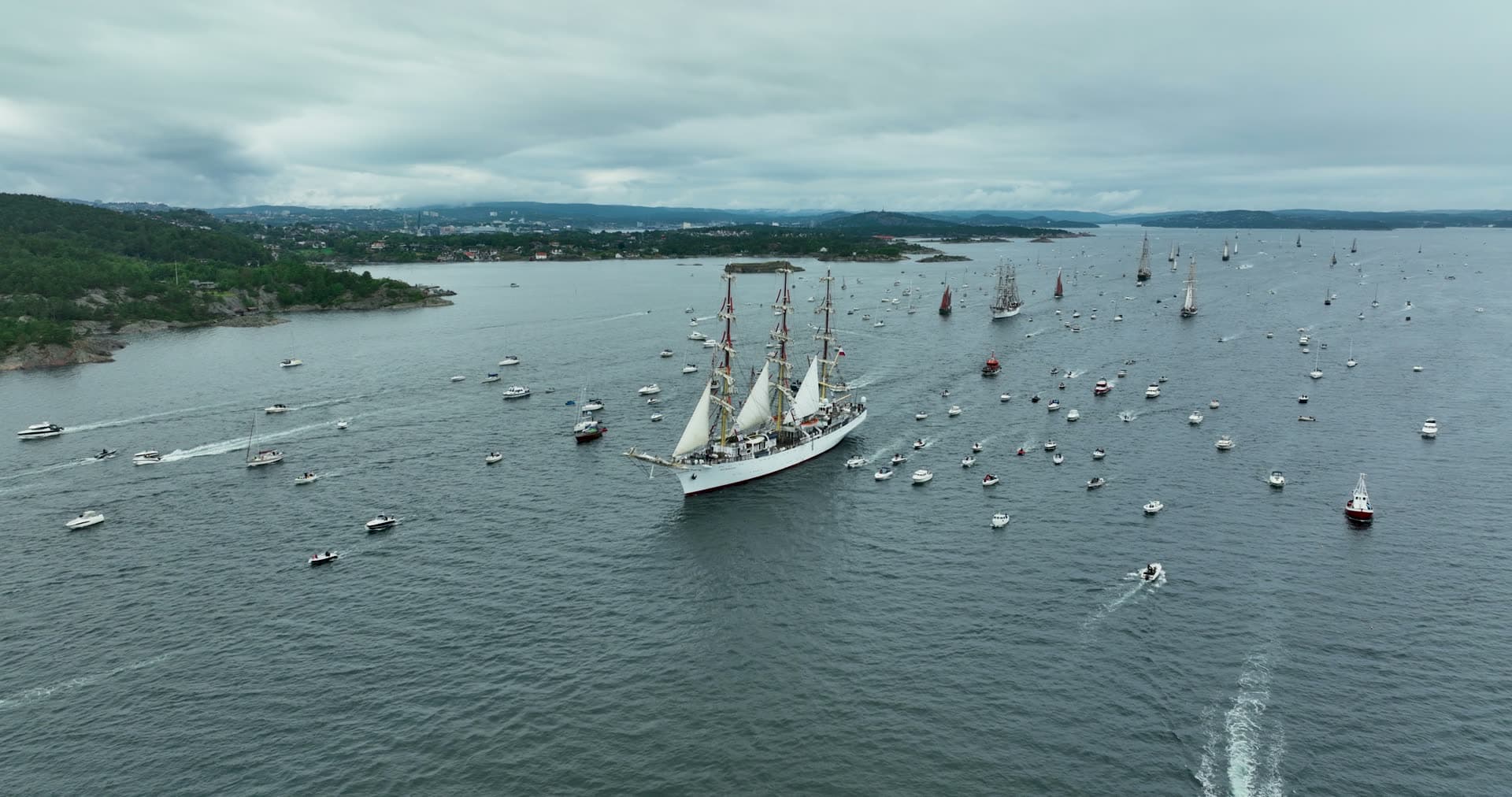 Tall ship parade escorted by small boats, Kristiansand, Norway