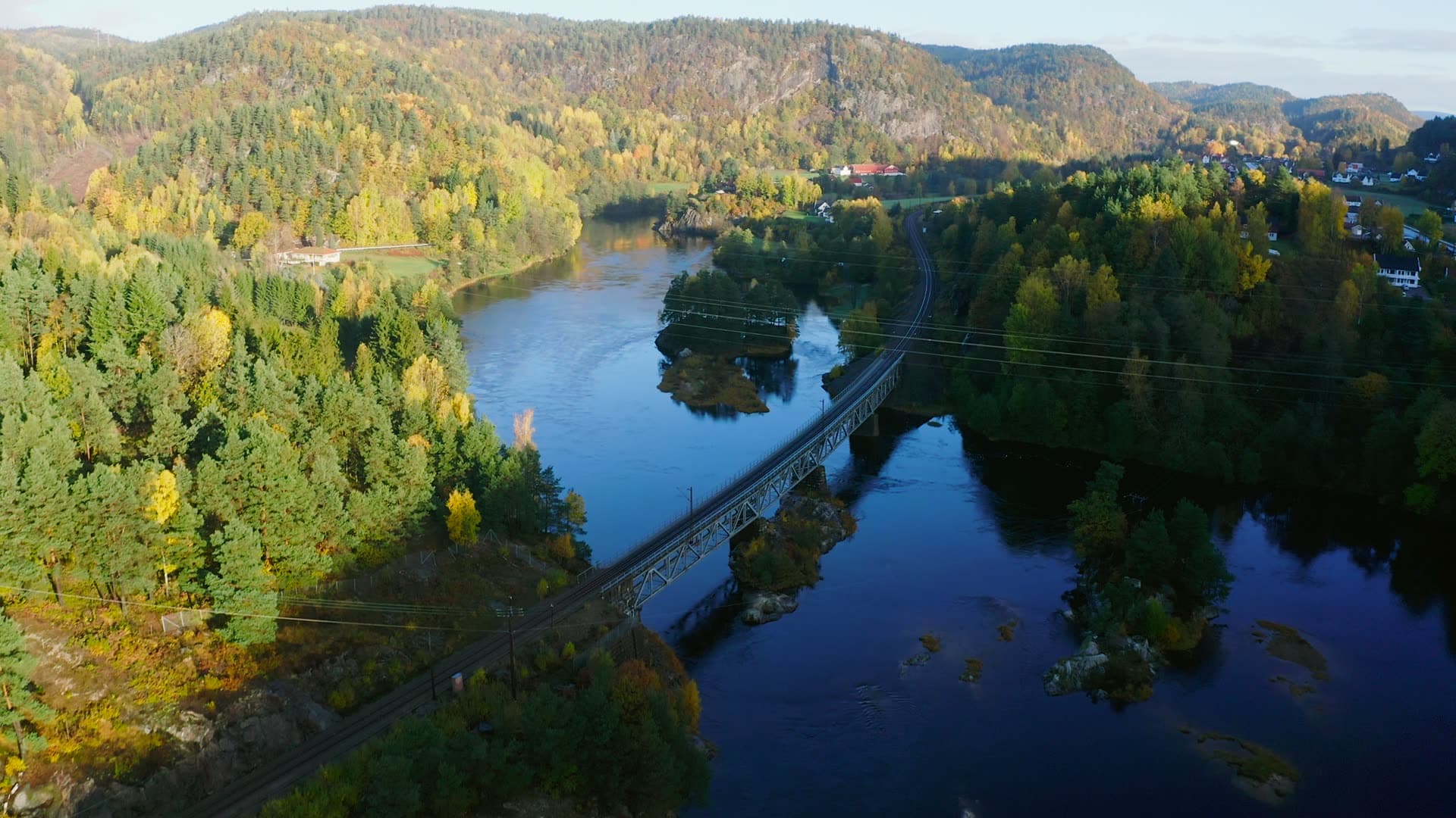 Steel railway bridge over autumn river, Kvarstein, Norway