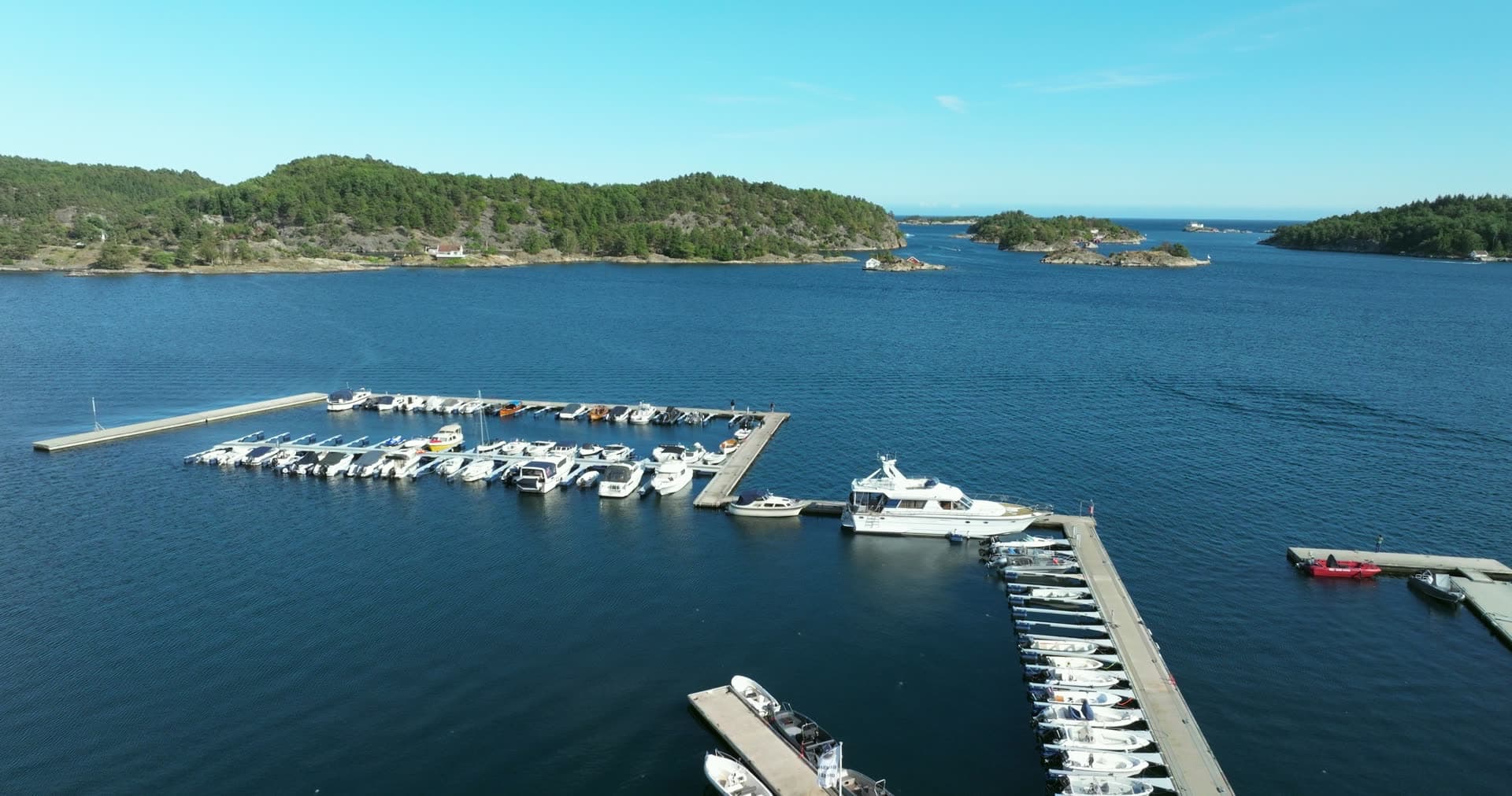 Marina pontoons with motorboats and one yacht, Lillesand, Norway