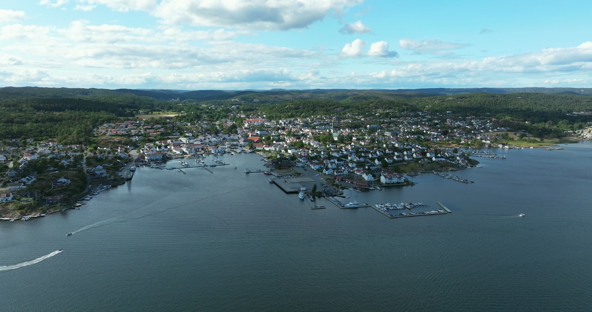 Boats crossing the fjord toward town marina, Lillesand, Norway