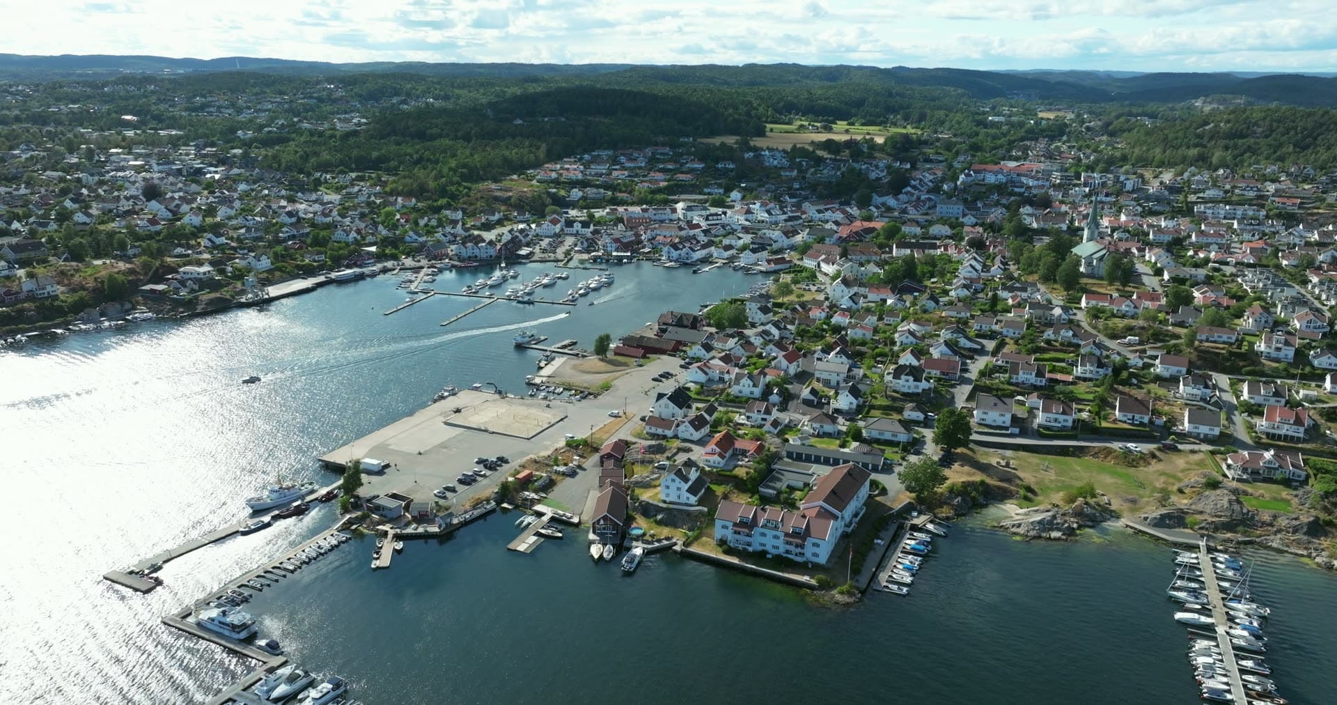 Marina piers and quay by white wooden houses, Lillesand, Norway