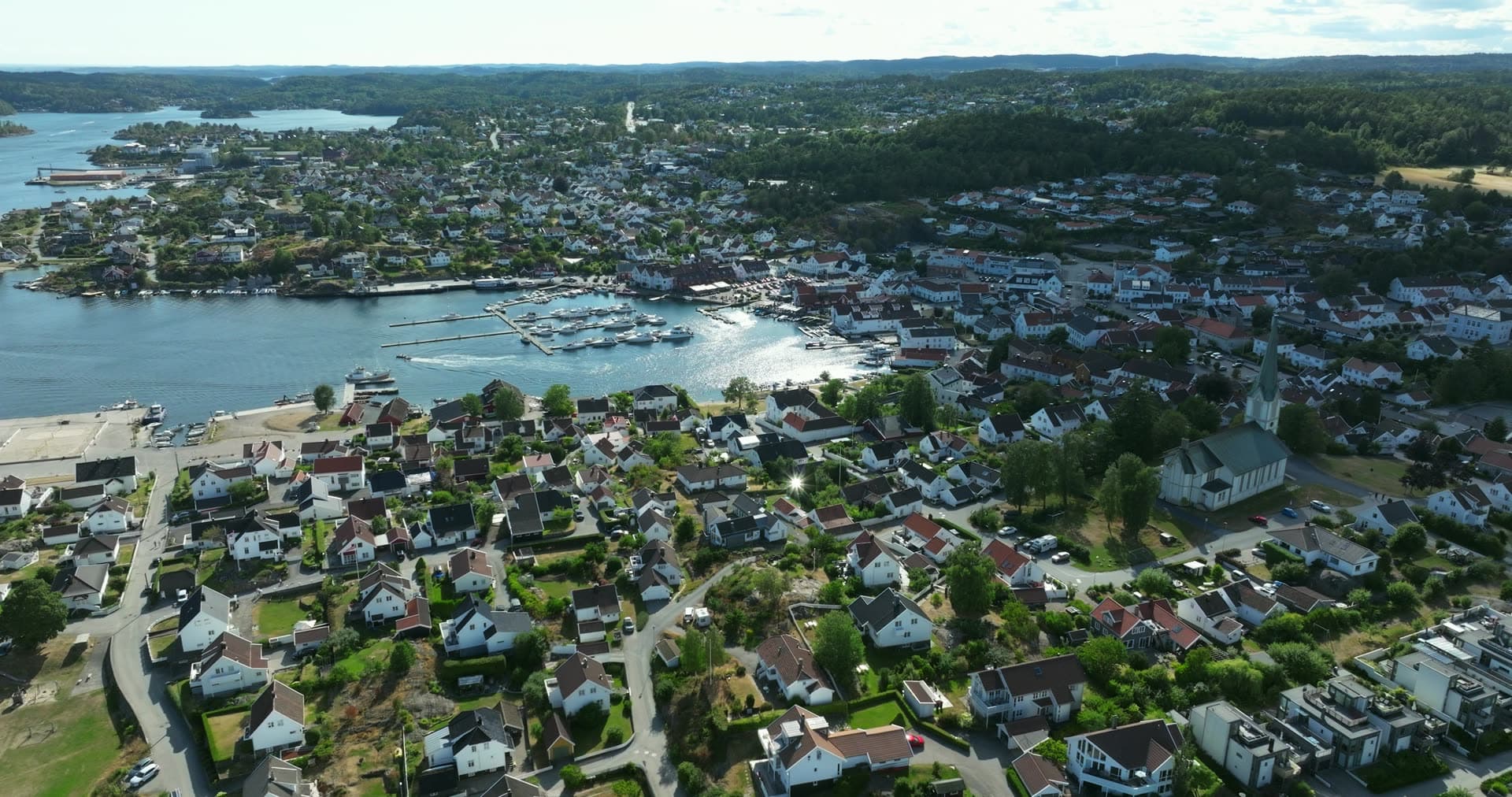 White church above harbor marina and houses, Lillesand, Norway