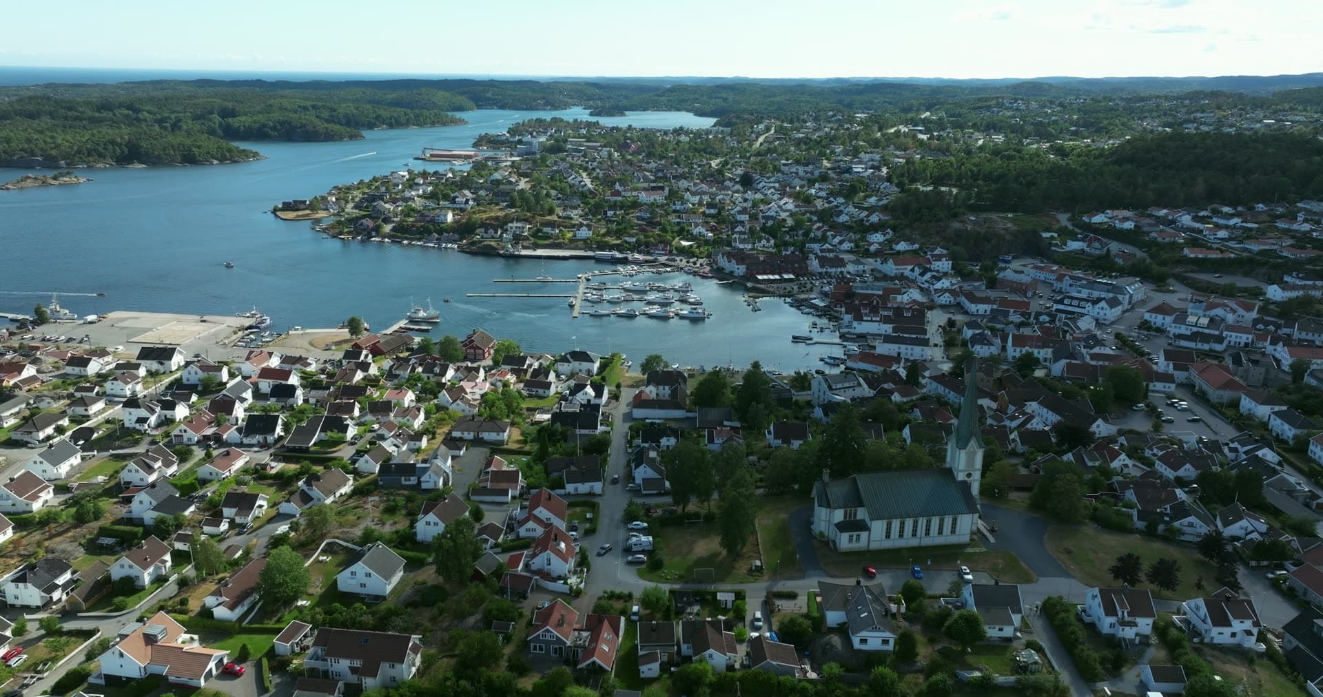 White church and marina above the harbour inlet, Lillesand, Norway
