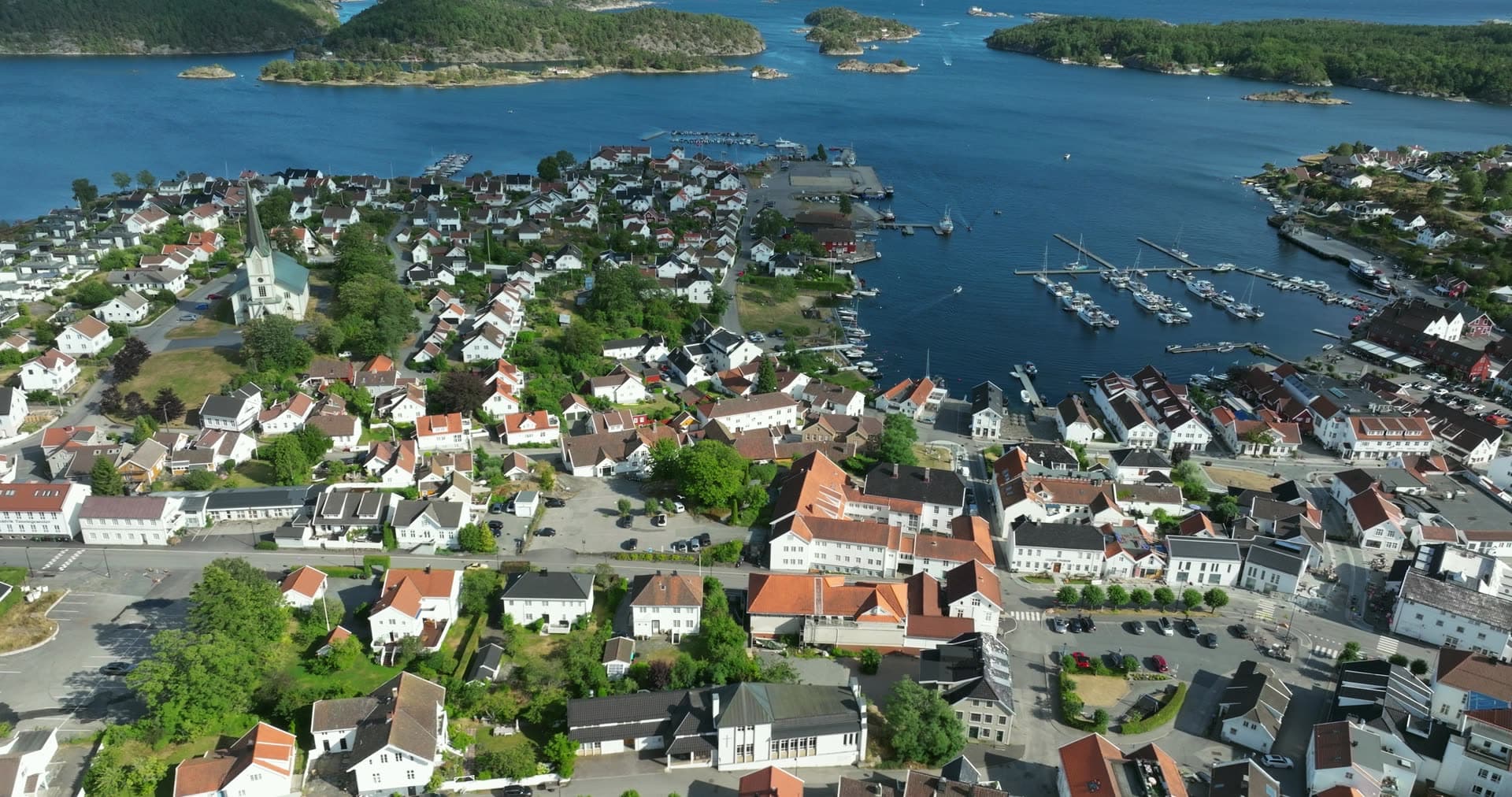 White church spire and marina pontoons, Lillesand, Norway