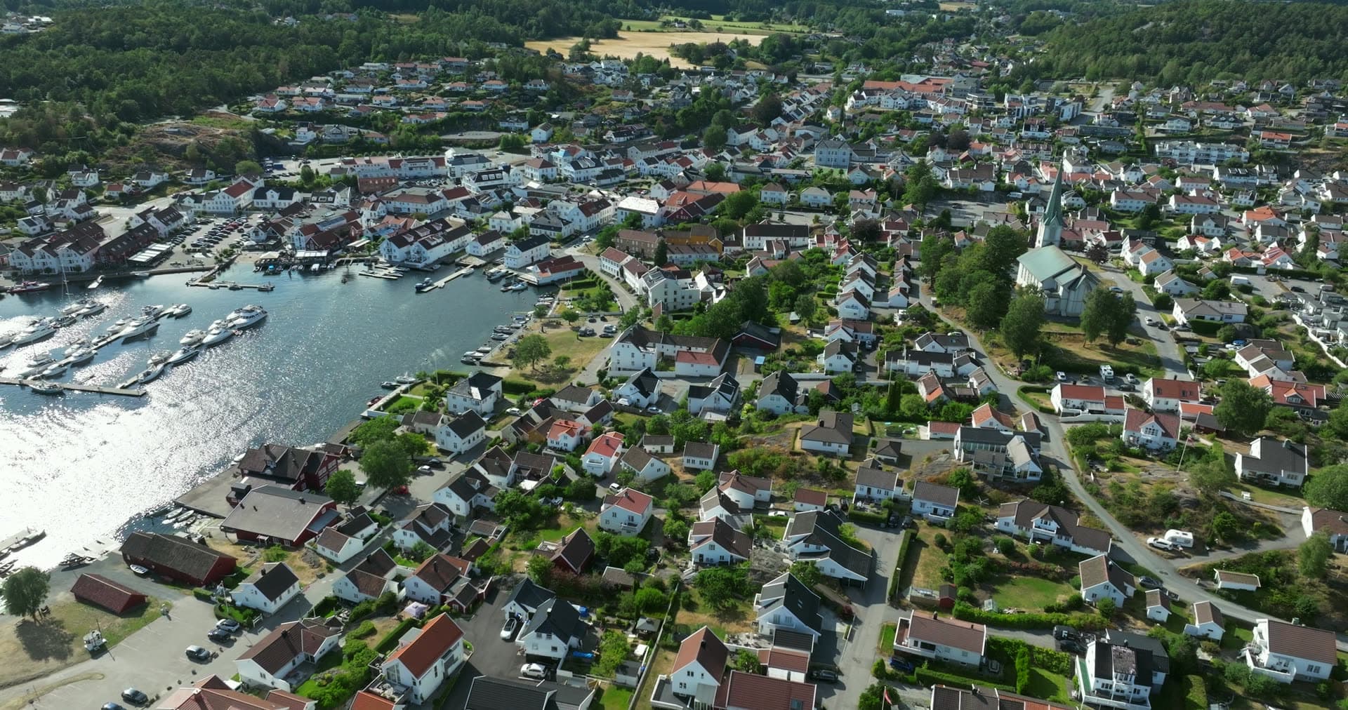 White houses and church spire above guest harbour, Lillesand, Norway