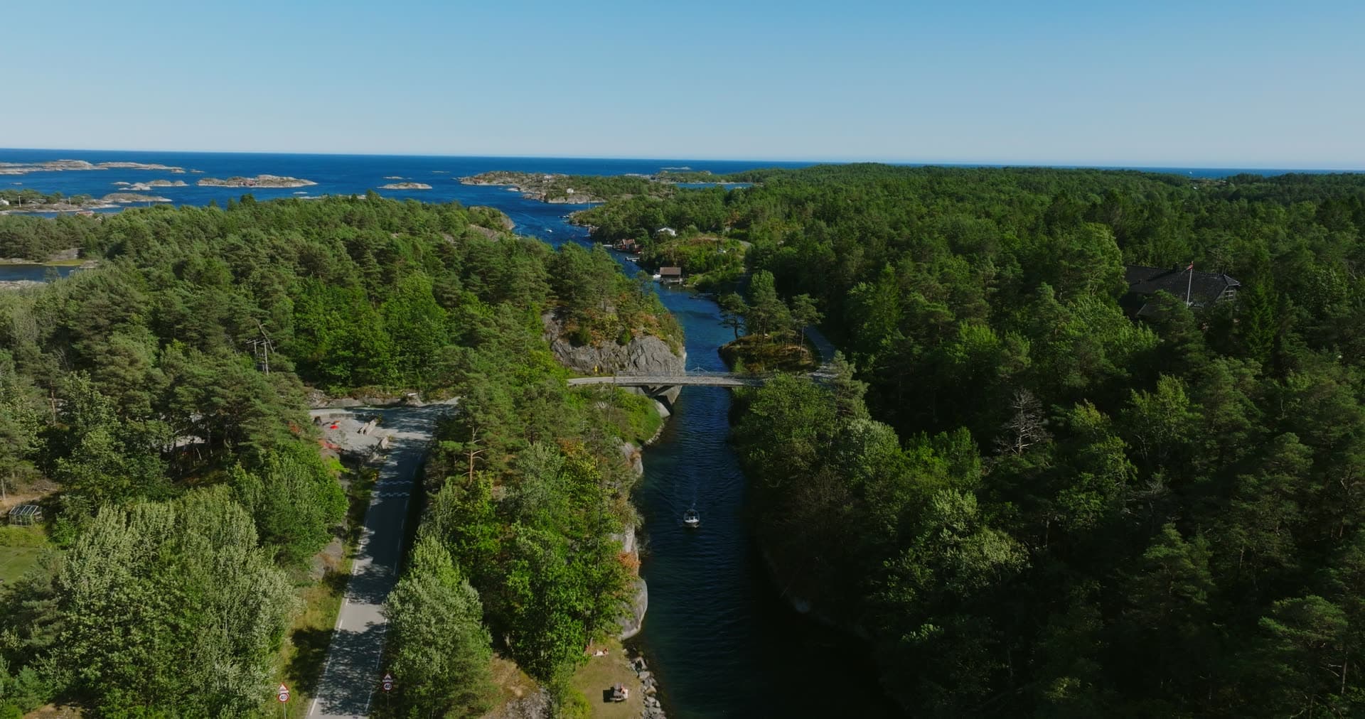 Road bridge over a narrow wooded sound, Lillesand, Norway