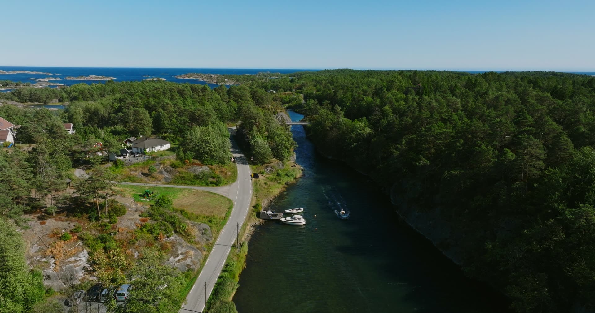 Small boat approaching the bridge in the sound, Lillesand, Norway