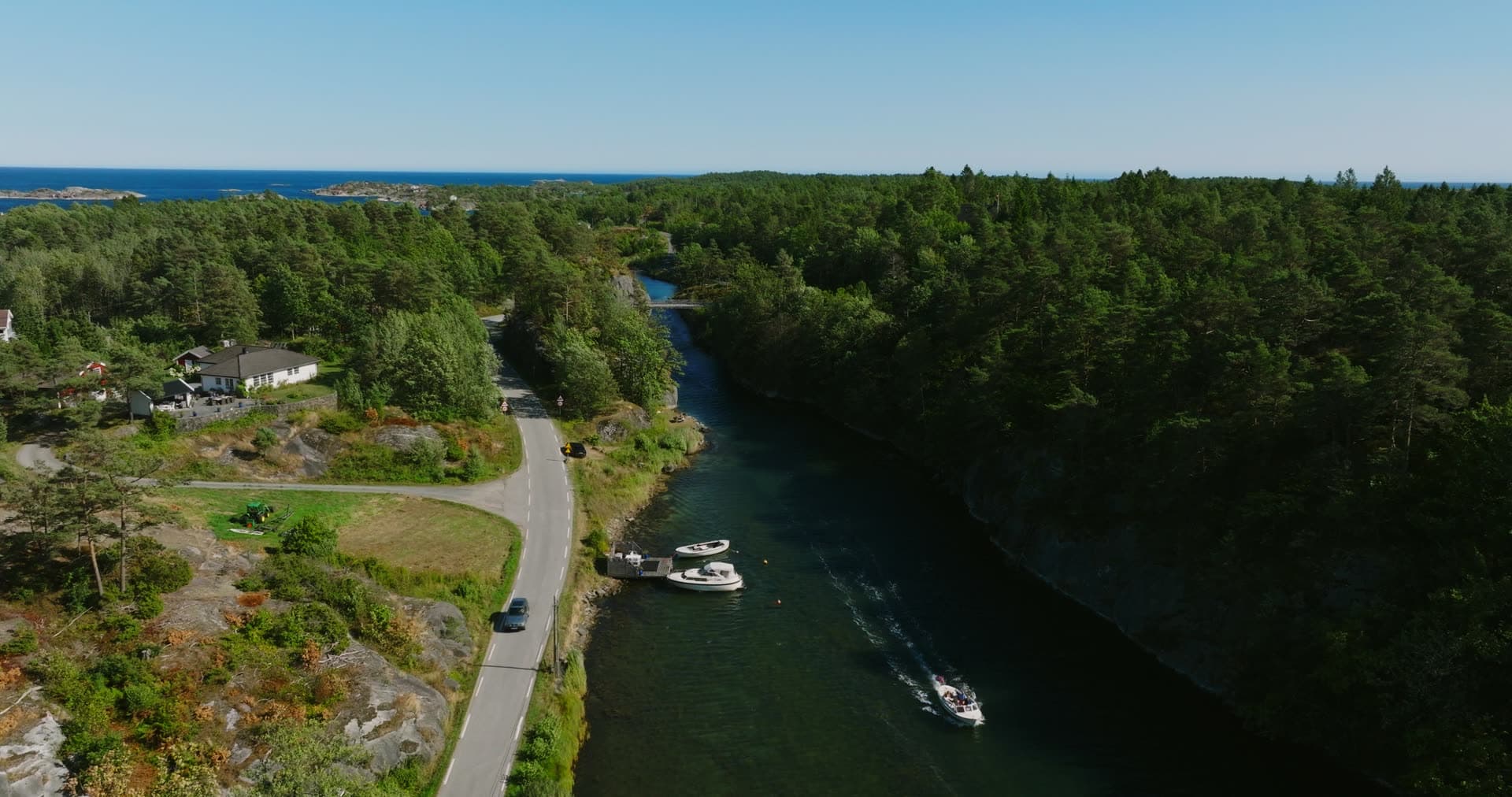 Motorboat leaving a wake down the narrow sound, Lillesand, Norway