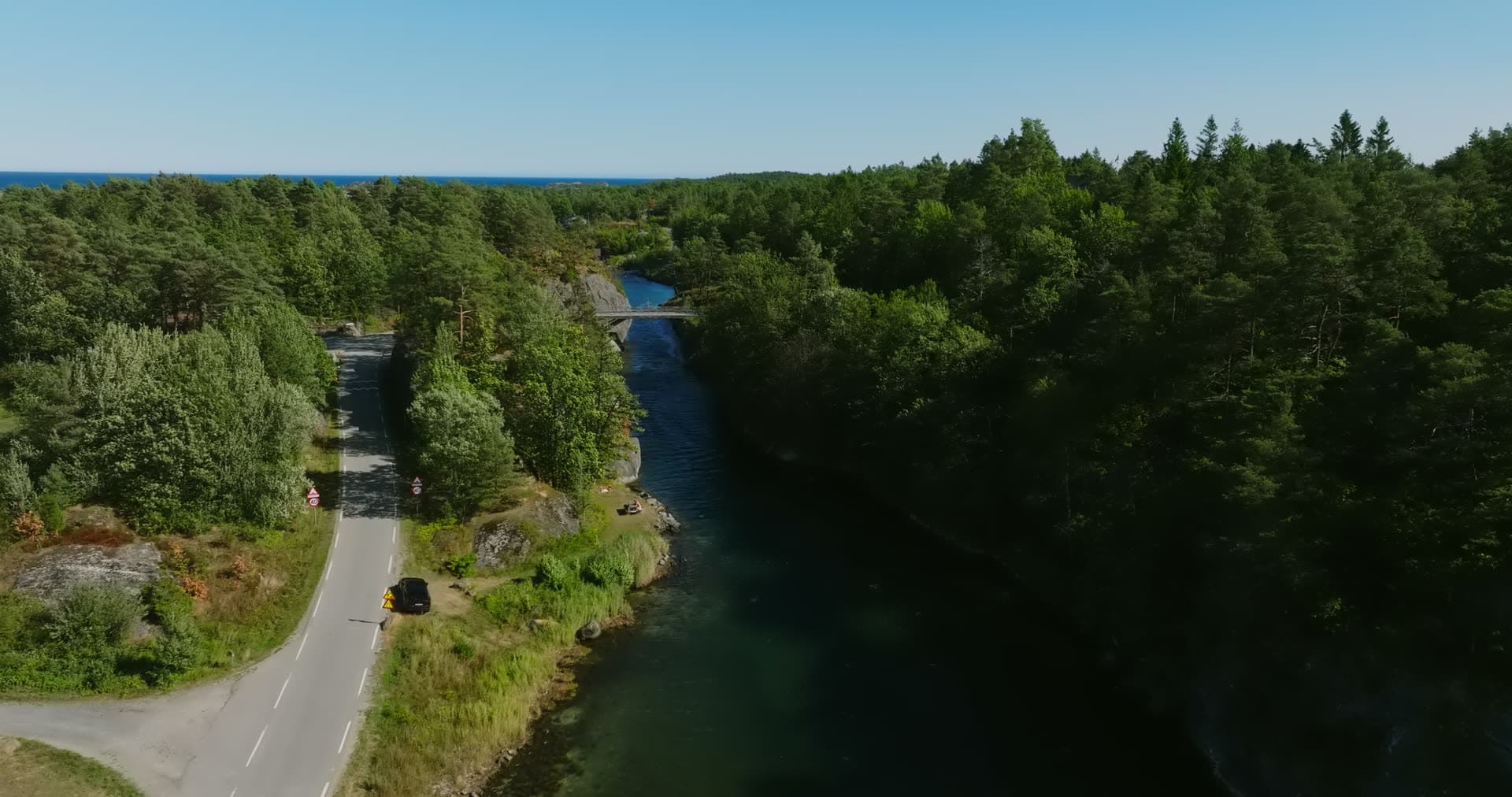 Shore road running toward the arched bridge, Lillesand, Norway