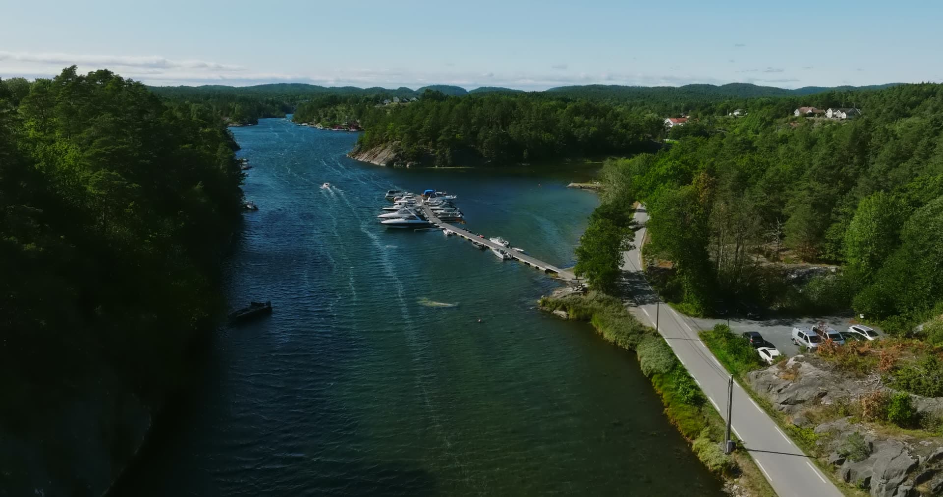 Floating jetty of motorboats by the shore road, Lillesand, Norway