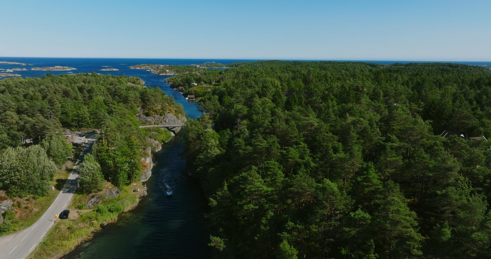 Pine canopy above the canal and its bridge, Lillesand, Norway