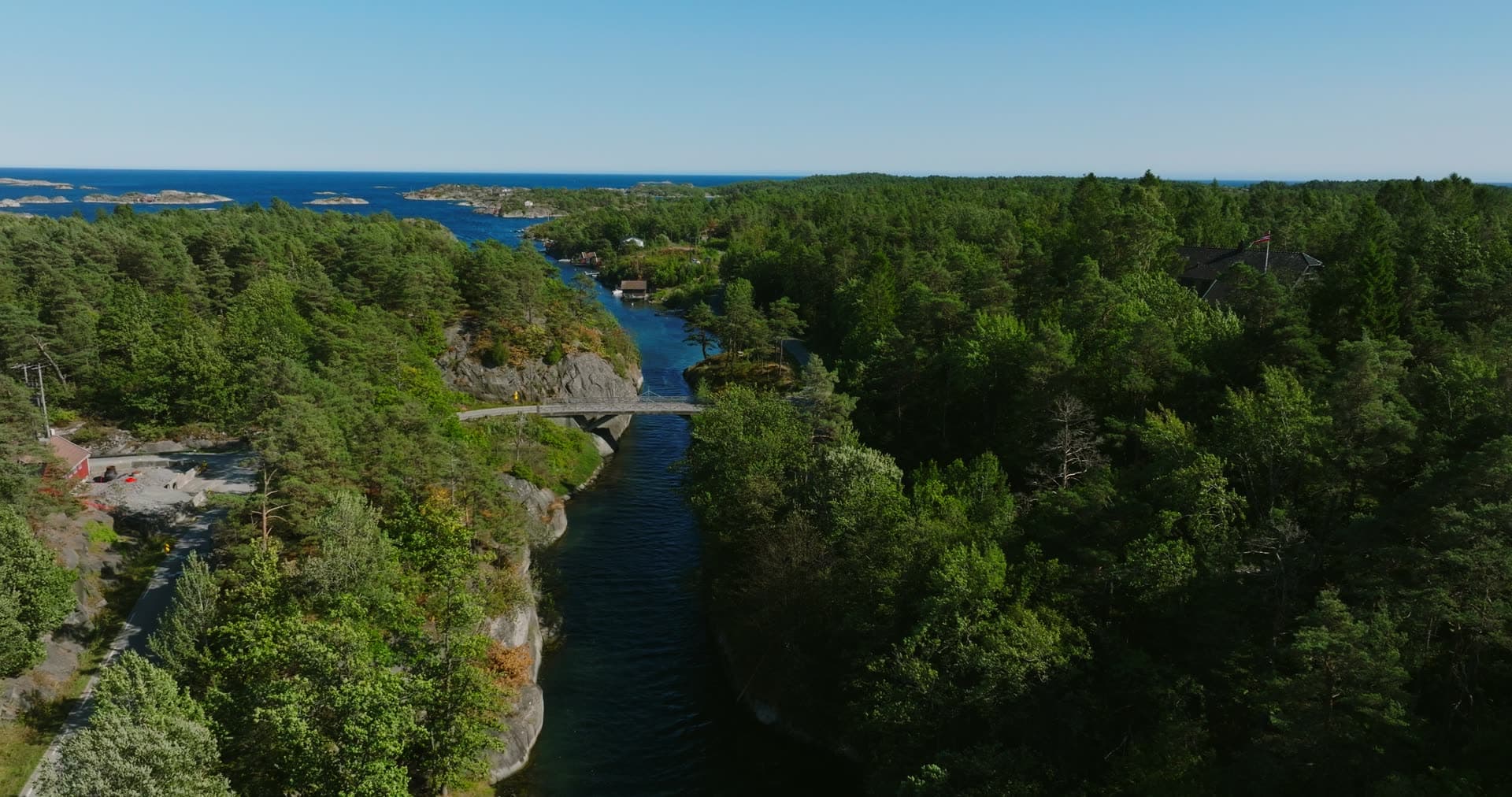 Cliff-sided canal cut through the pine forest, Lillesand, Norway