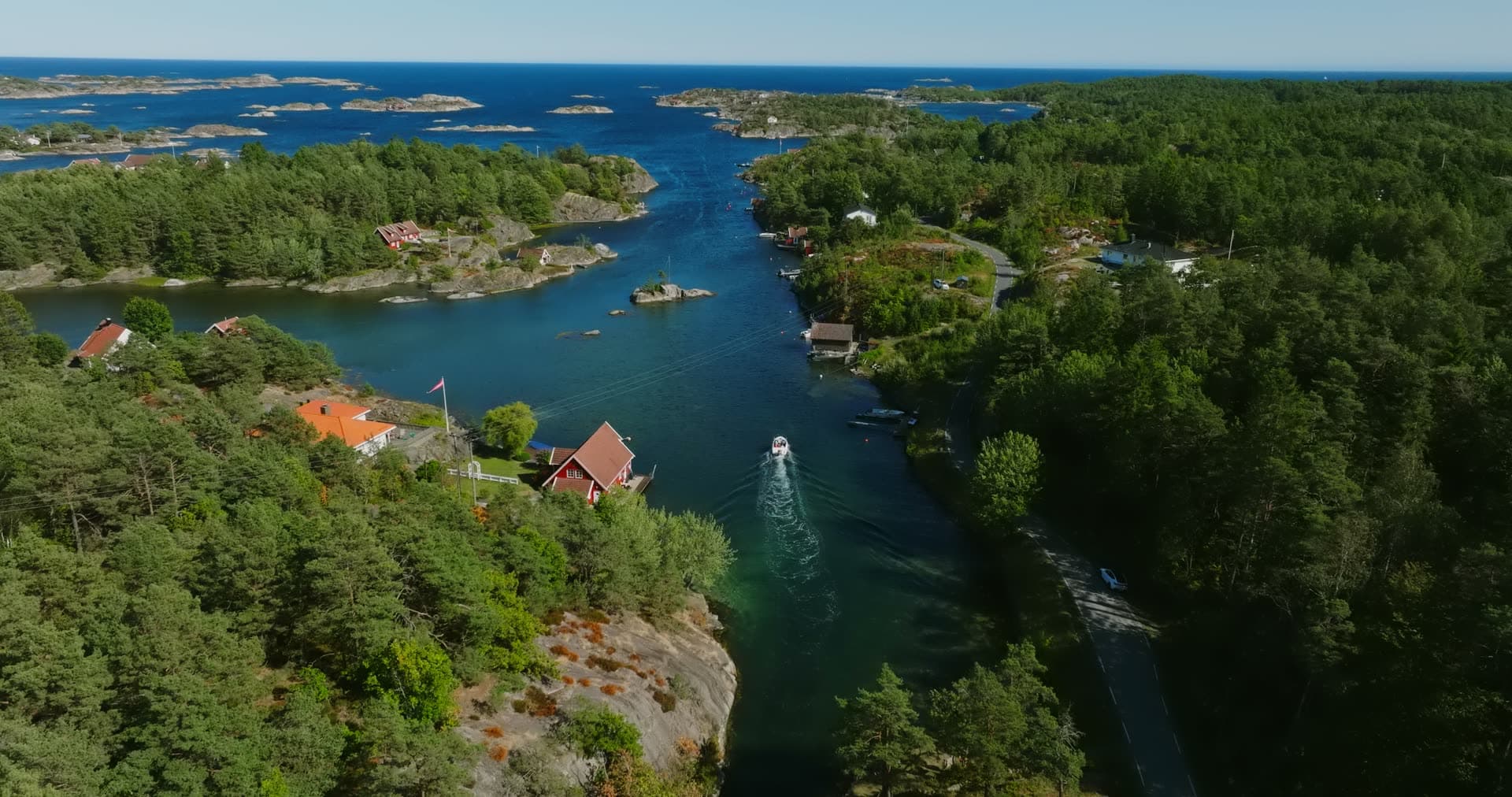 Red cabins on the point above the channel, Lillesand, Norway