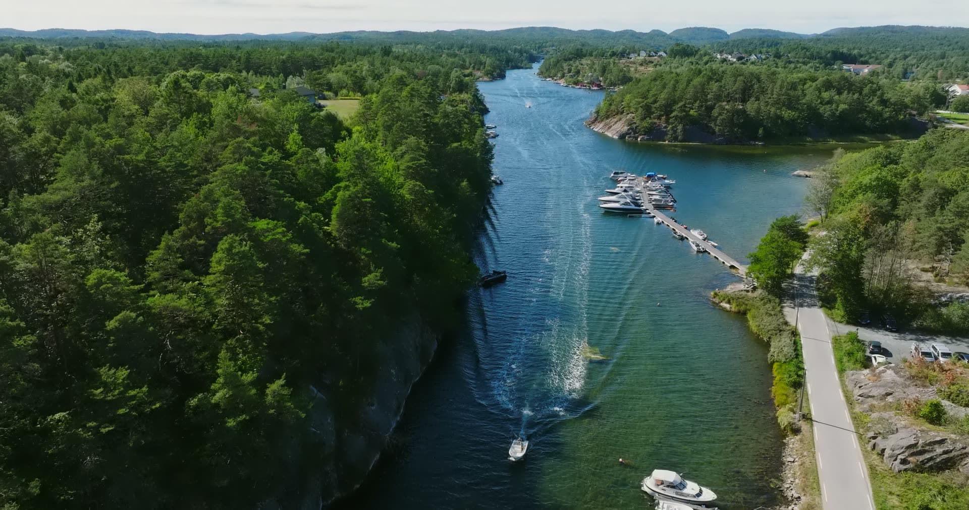 Speedboat wake down the sound past the marina, Lillesand, Norway