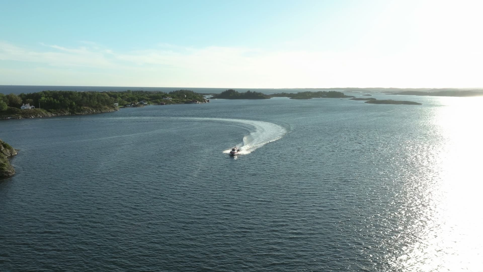 Speedboat carving a wide wake turn, Lillesand, Norway