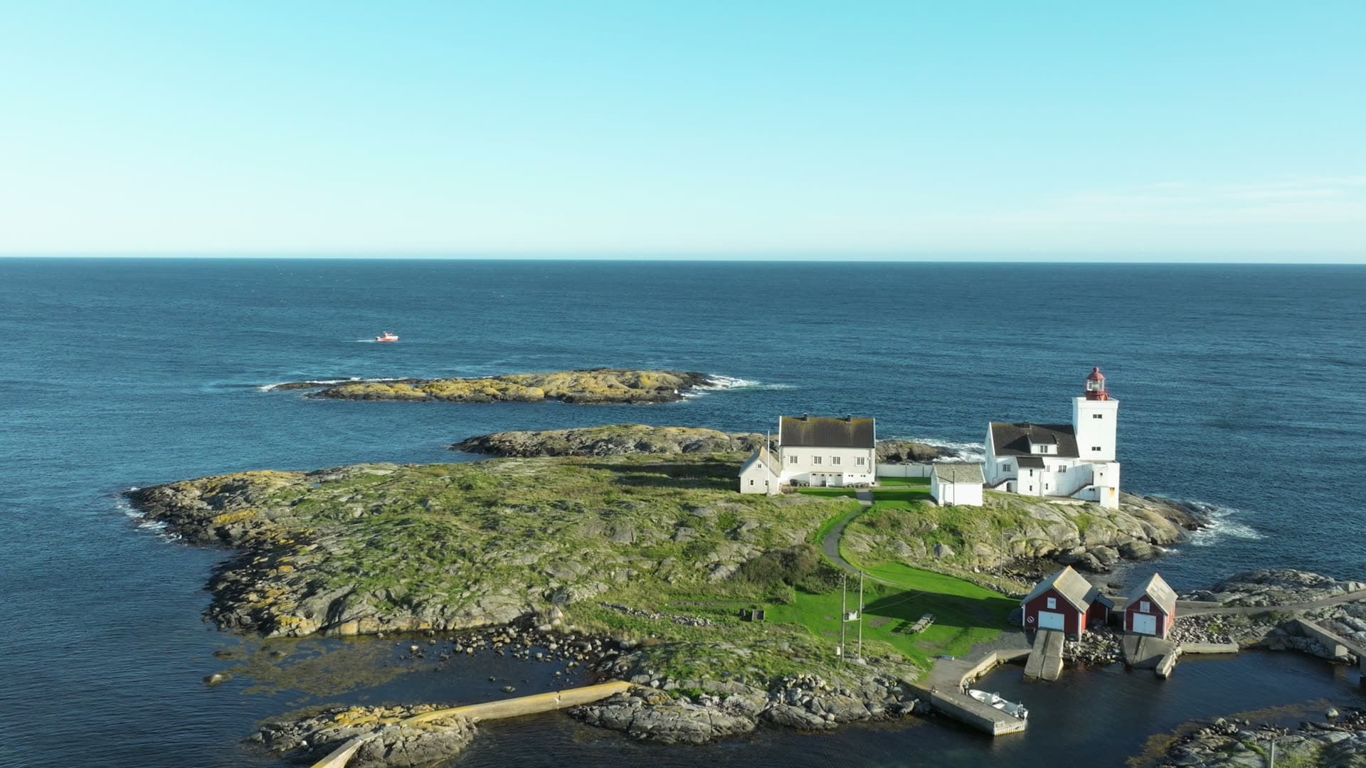 Lighthouse island with red boathouses, Lillesand, Norway