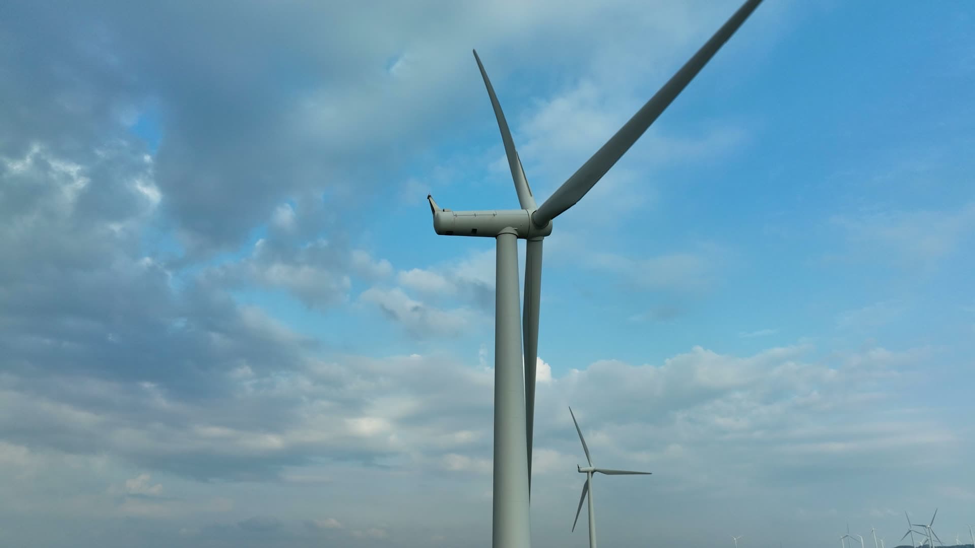 Rising past wind turbine nacelle and blades, Lista, Norway