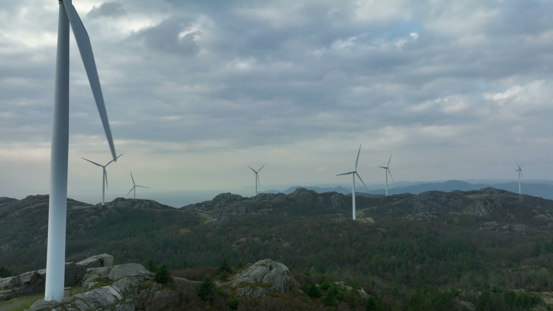 Wind turbines on rocky forested ridge, Lista, Norway