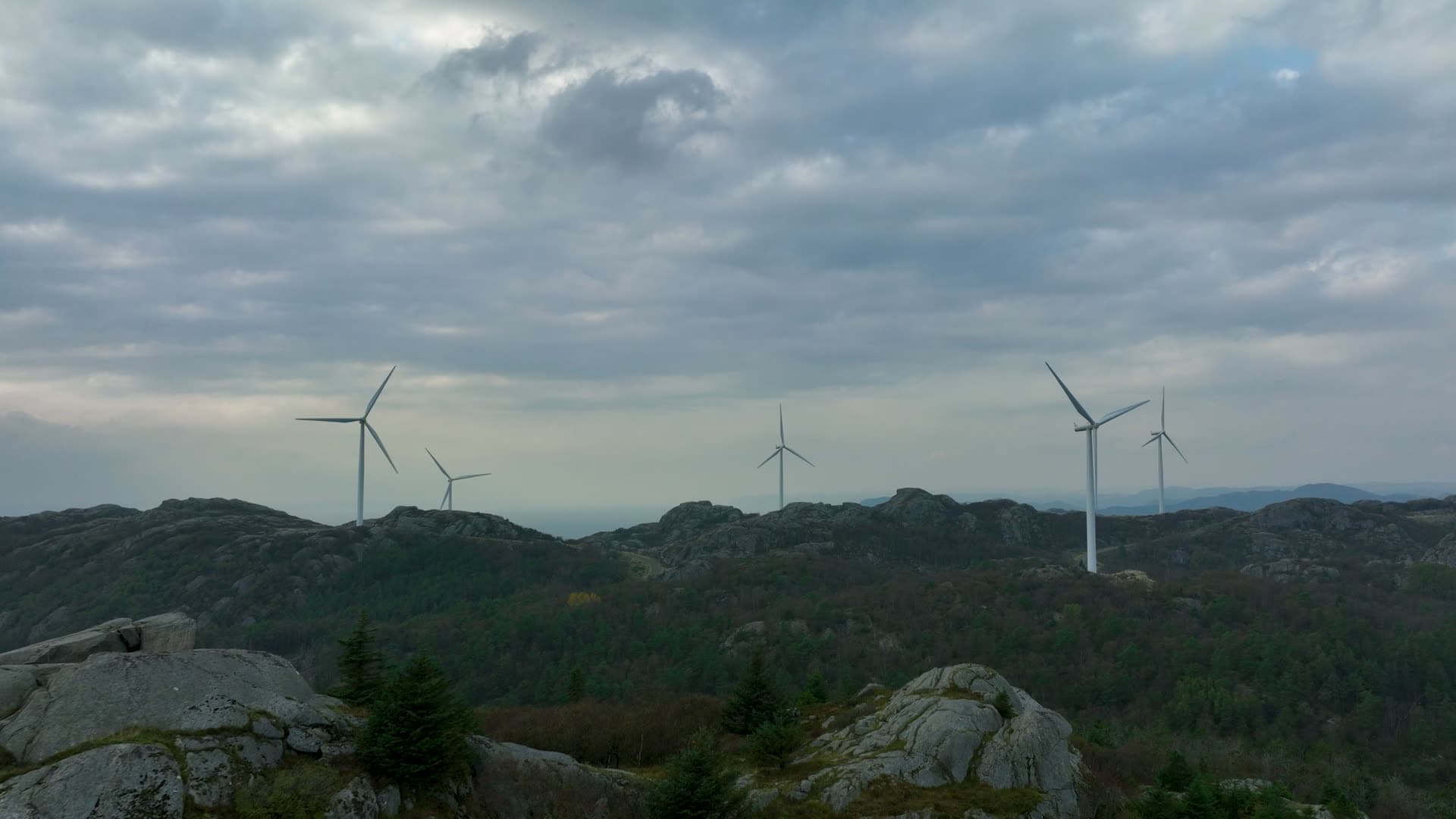 Wind turbines on rocky forested ridge, Lista, Norway